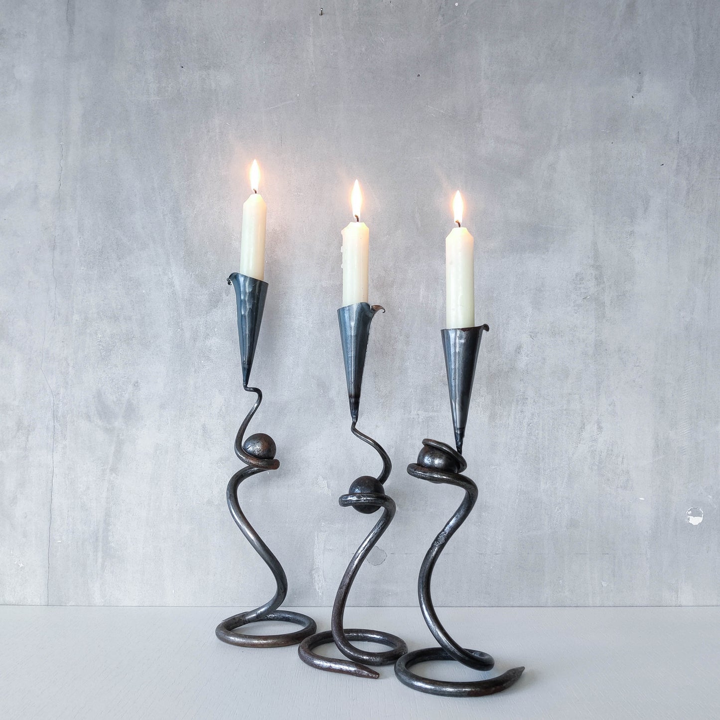 Trio of sculptural handmade wrought iron welded steel candle holders with steel balls