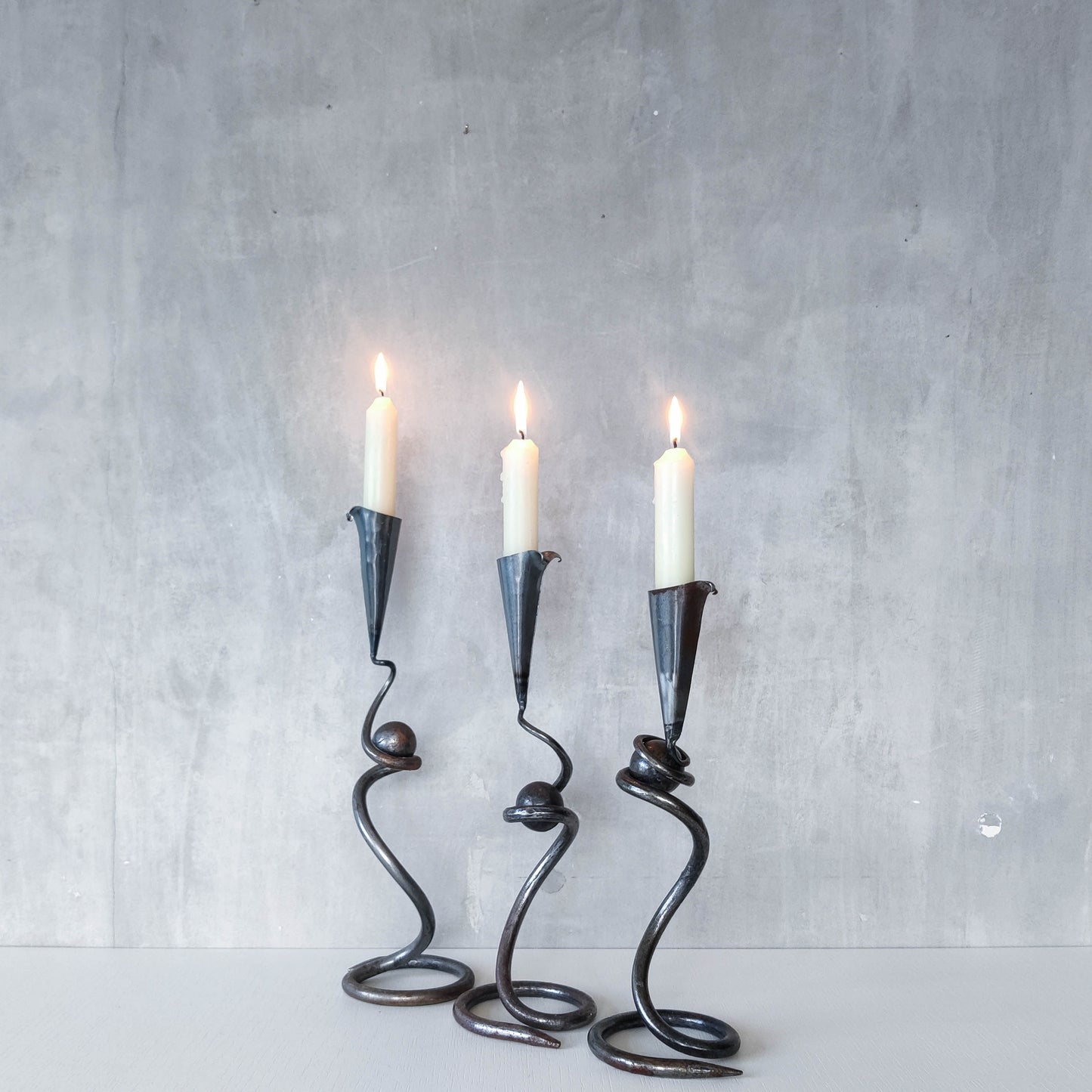 Trio of sculptural handmade wrought iron welded steel candle holders with steel balls