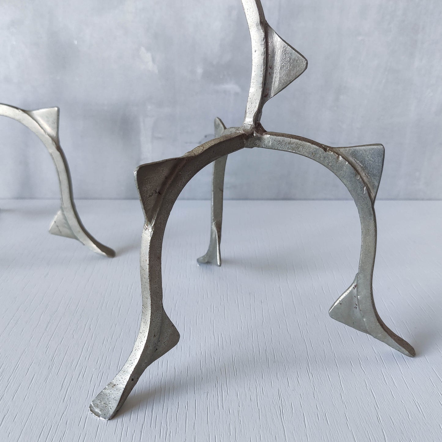 Pair of tall vintage sculptural wavy zigzag footed aluminium candle holders