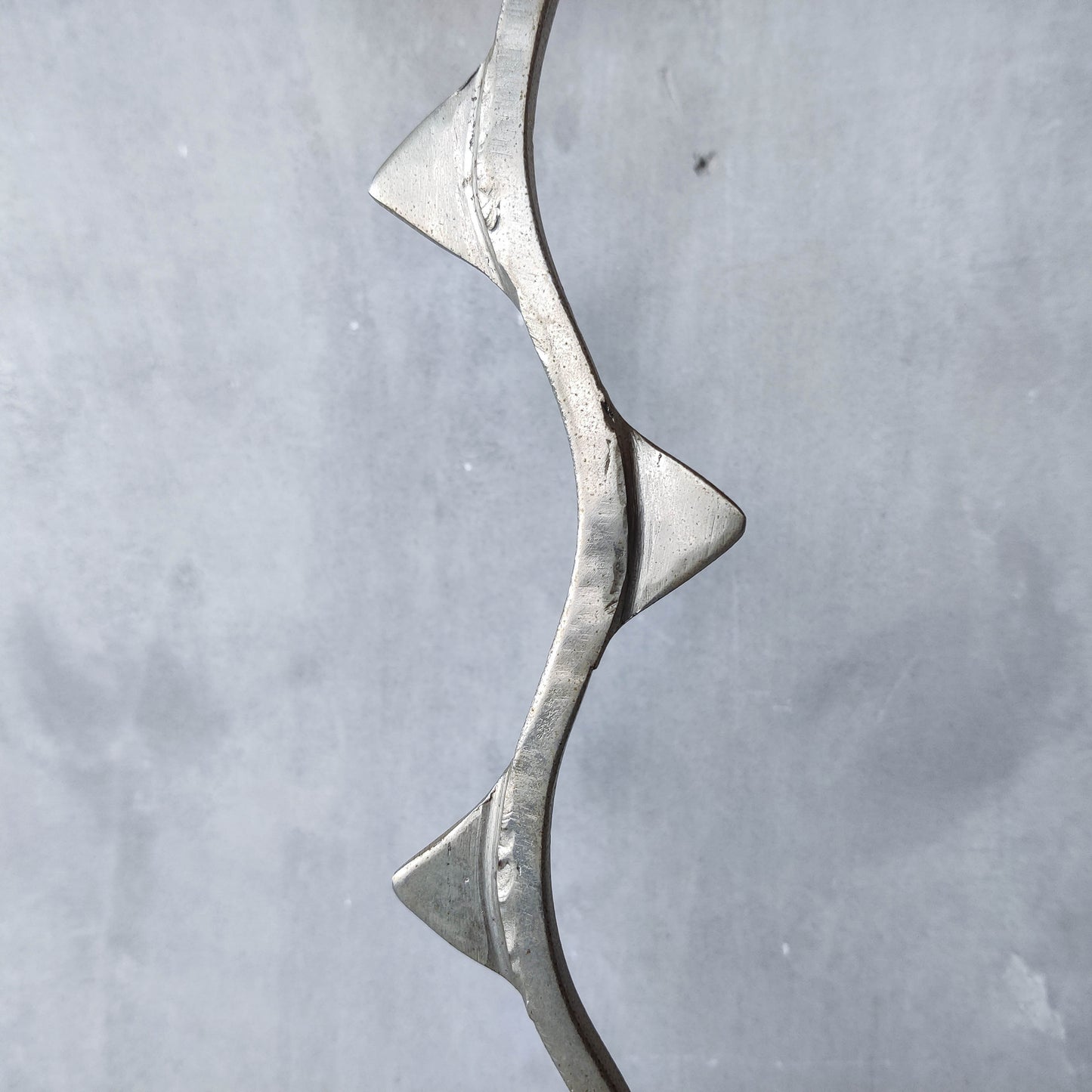 Pair of tall vintage sculptural wavy zigzag footed aluminium candle holders