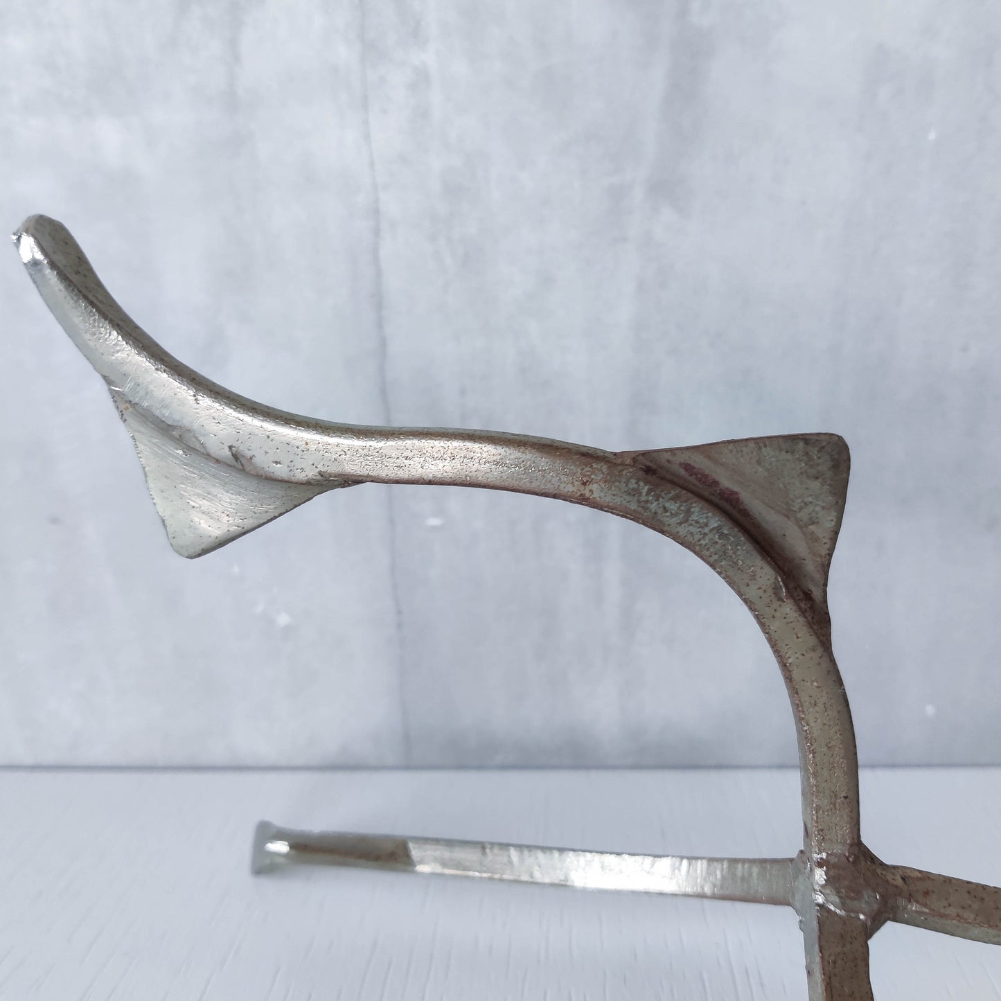 Pair of tall vintage sculptural wavy zigzag footed aluminium candle holders