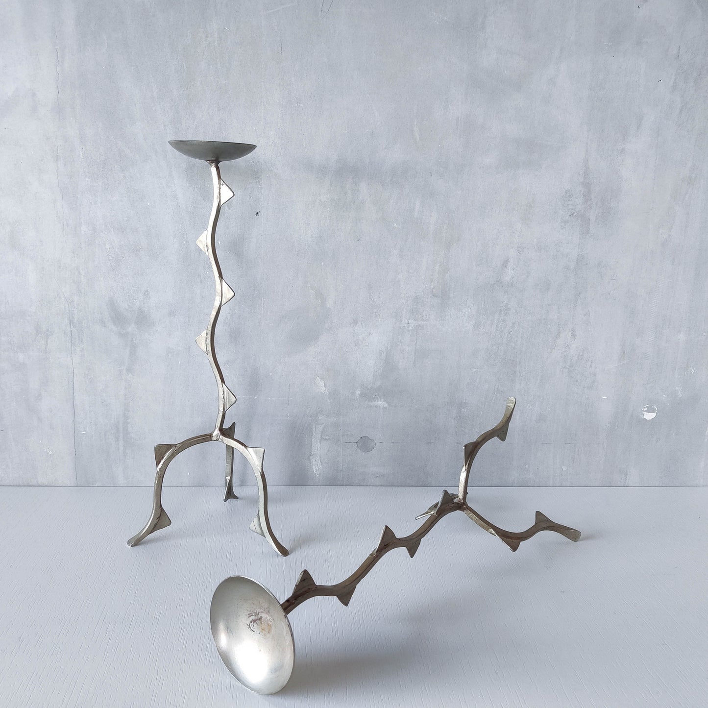 Pair of tall vintage sculptural wavy zigzag footed aluminium candle holders