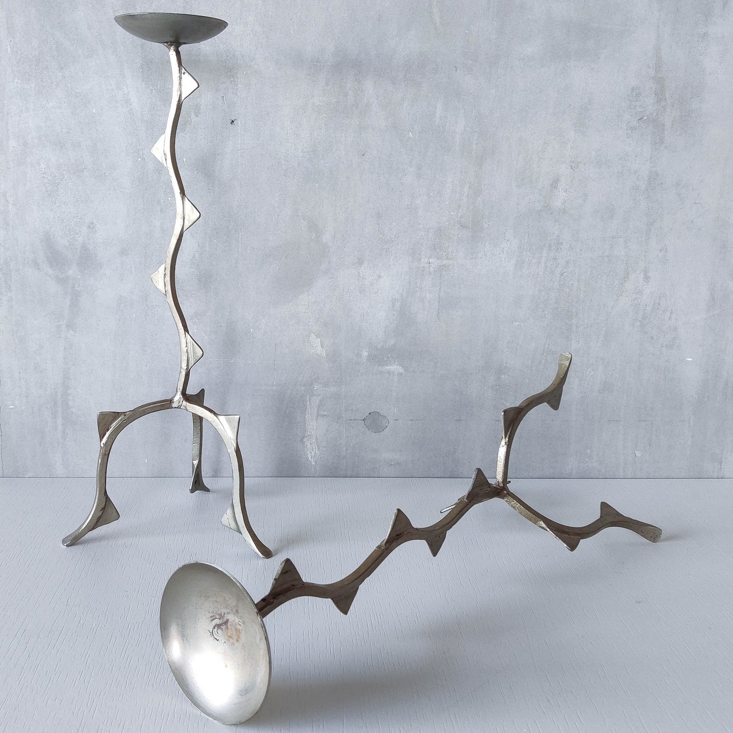 Pair of tall vintage sculptural wavy zigzag footed aluminium candle holders