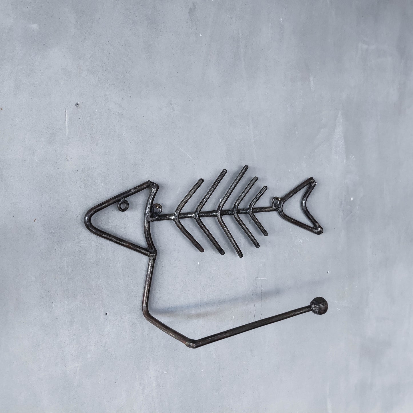 Vintage artisan made metalwork welded steel fish skeleton toilet roll holder