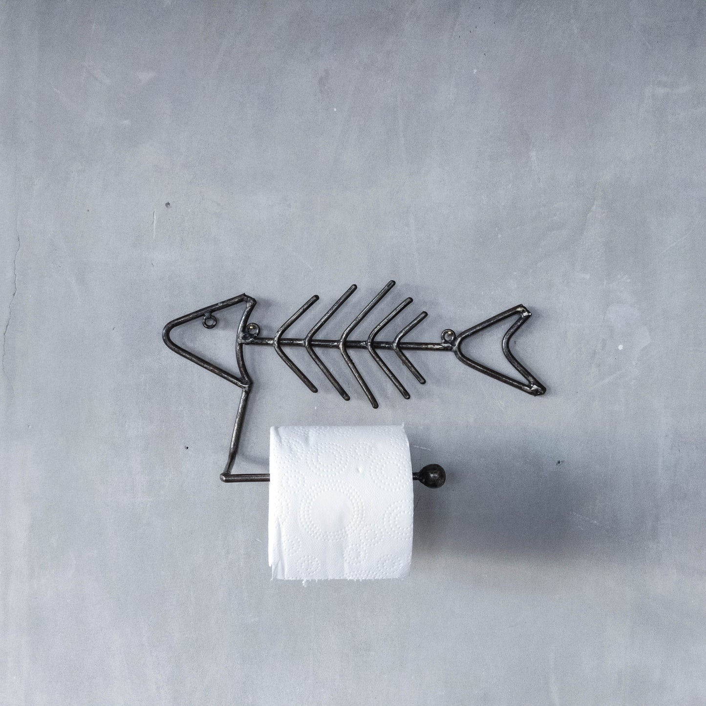 Vintage artisan made metalwork welded steel fish skeleton toilet roll holder