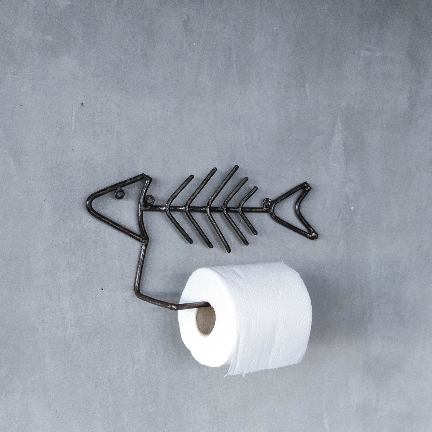 Vintage artisan made metalwork welded steel fish skeleton toilet roll holder