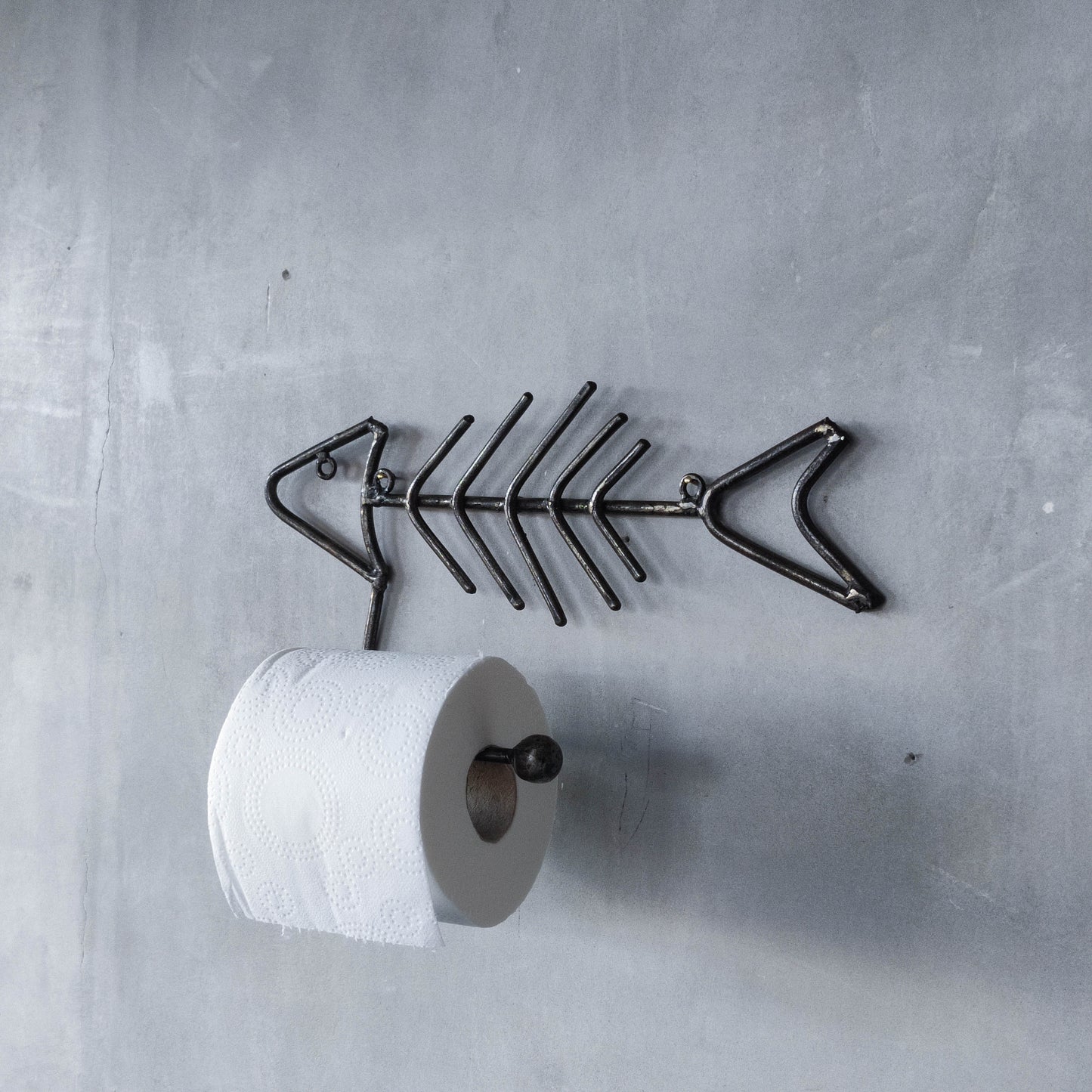 Vintage artisan made metalwork welded steel fish skeleton toilet roll holder