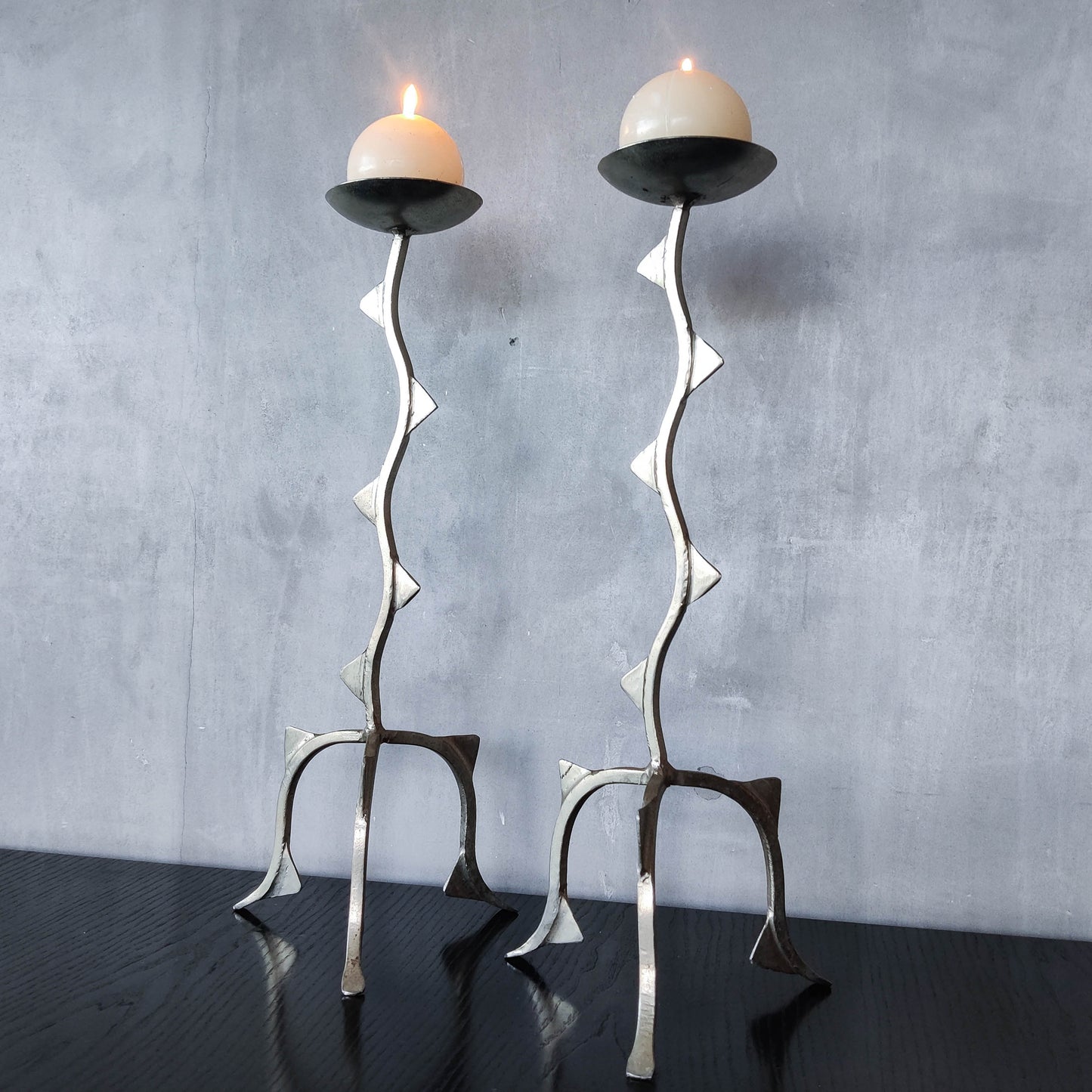 Pair of tall vintage sculptural wavy zigzag footed aluminium candle holders