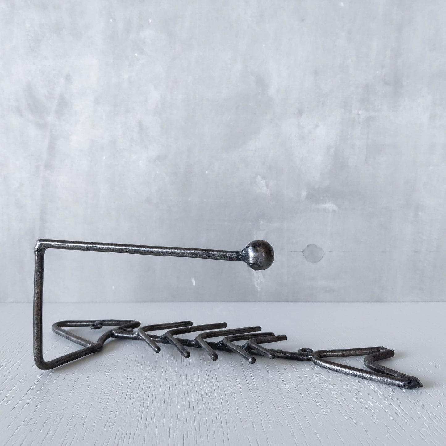 Vintage artisan made metalwork welded steel fish skeleton toilet roll holder