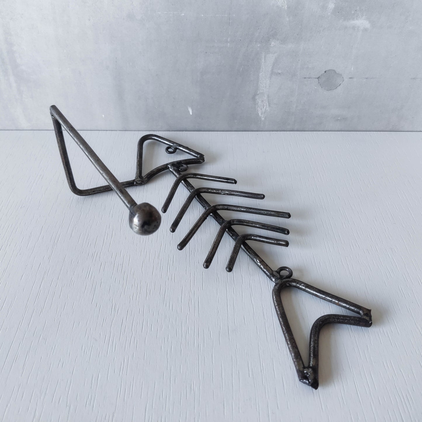 Vintage artisan made metalwork welded steel fish skeleton toilet roll holder