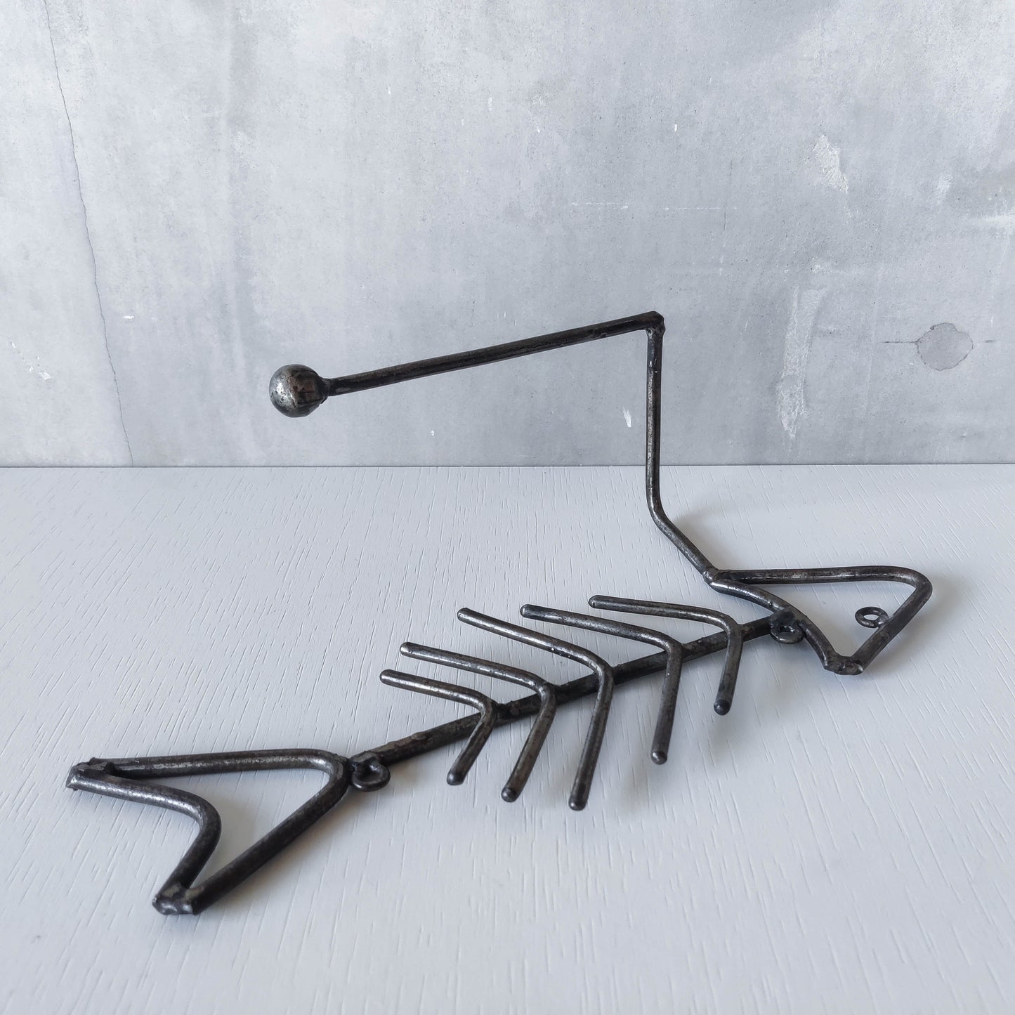 Vintage artisan made metalwork welded steel fish skeleton toilet roll holder