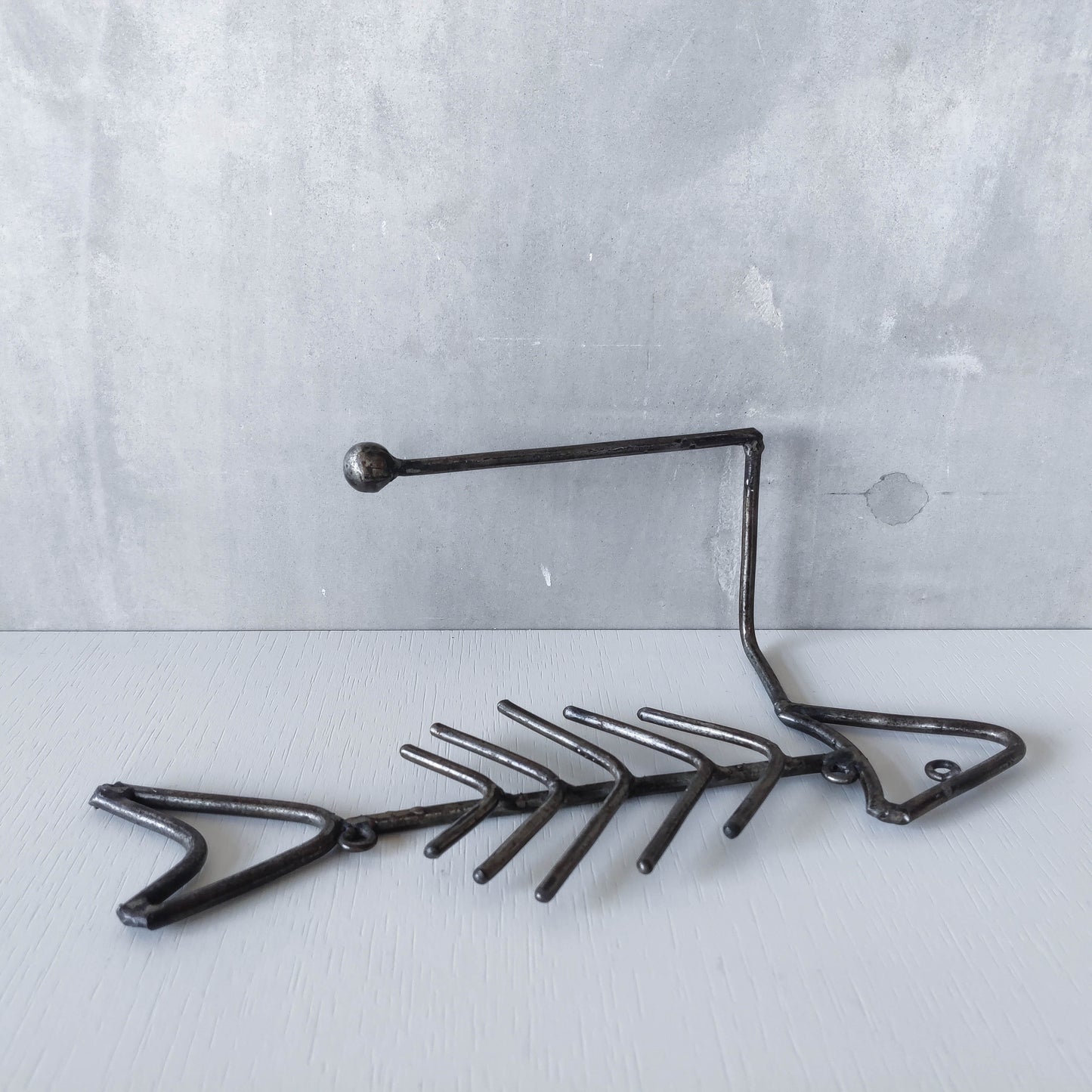 Vintage artisan made metalwork welded steel fish skeleton toilet roll holder