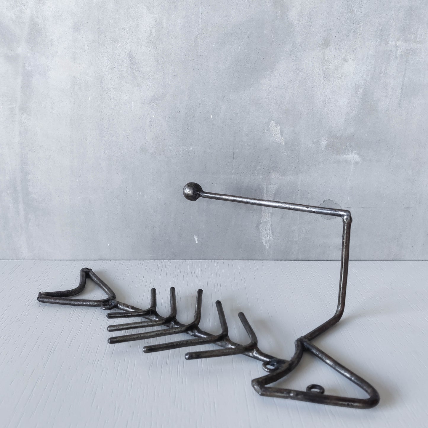 Vintage artisan made metalwork welded steel fish skeleton toilet roll holder