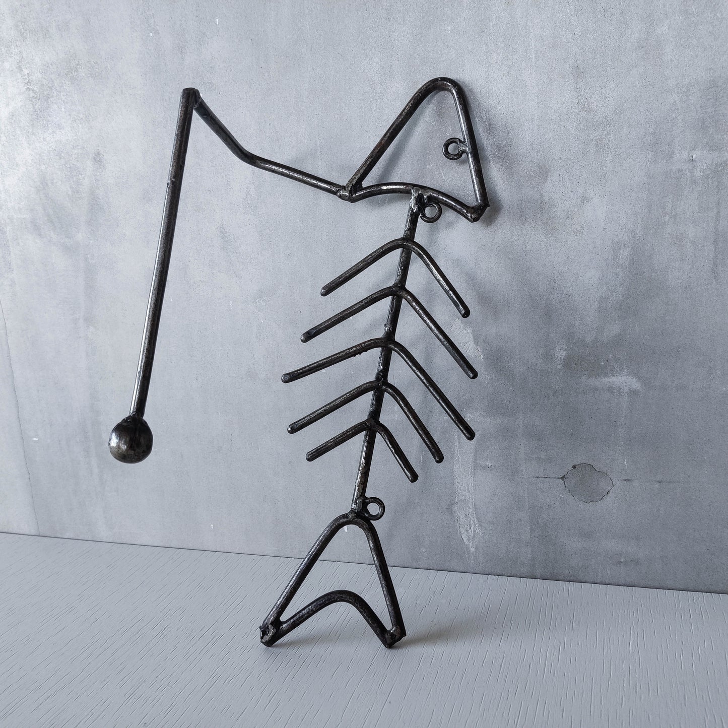 Vintage artisan made metalwork welded steel fish skeleton toilet roll holder