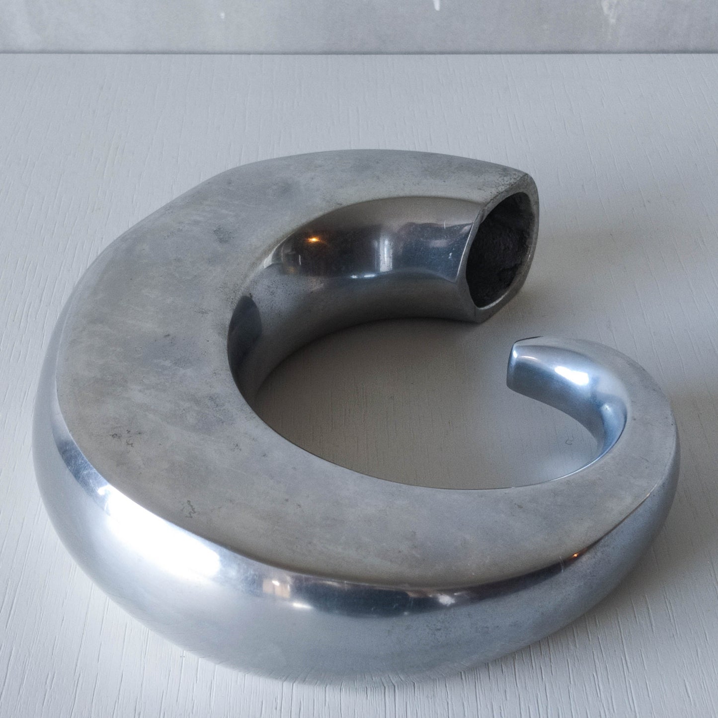 Vintage 1990s cast aluminium curved C shaped sculptural vase signed