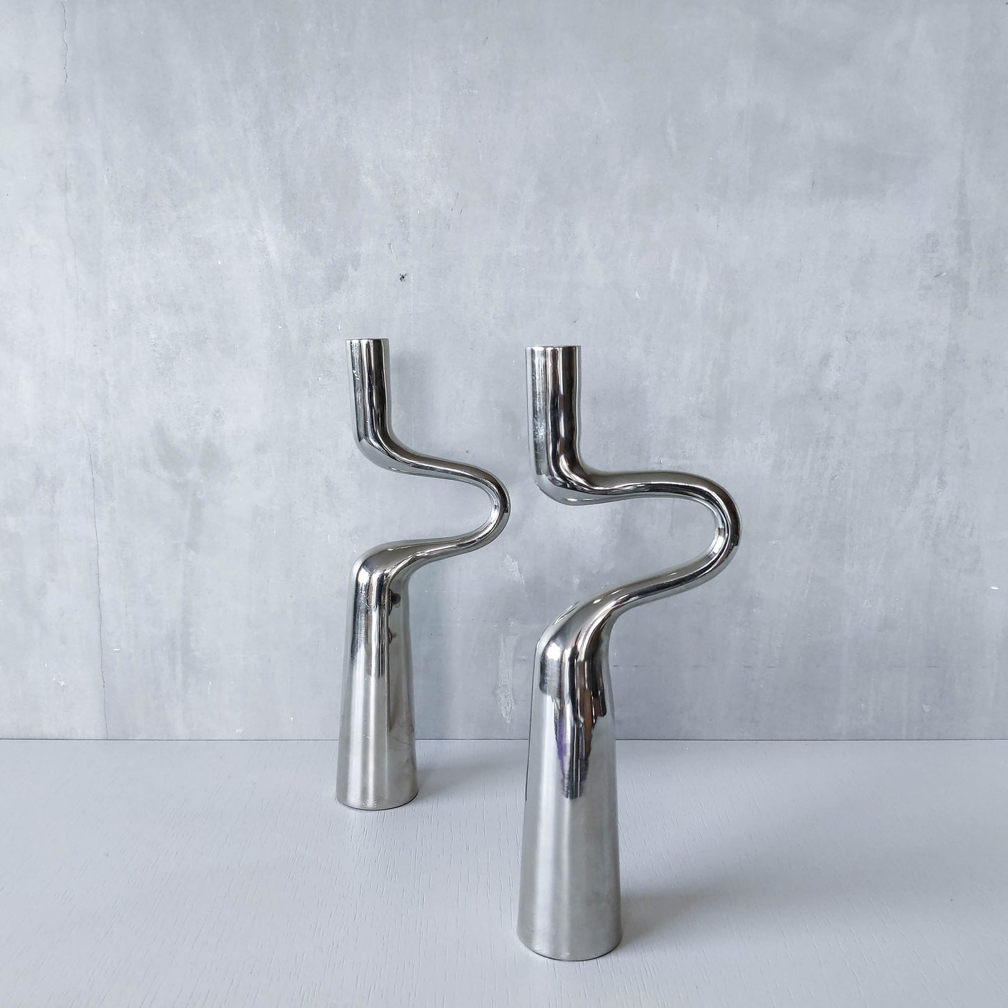 Pair of large curved chrome sculptural interlocking candle holders
