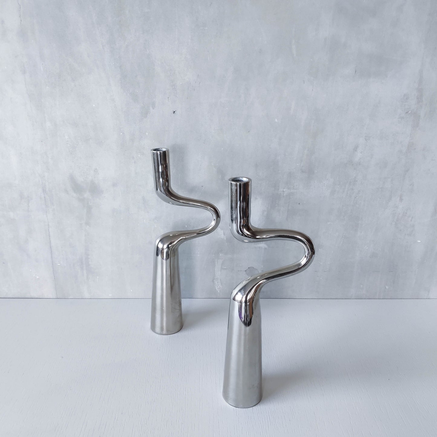 Pair of large curved chrome sculptural interlocking candle holders