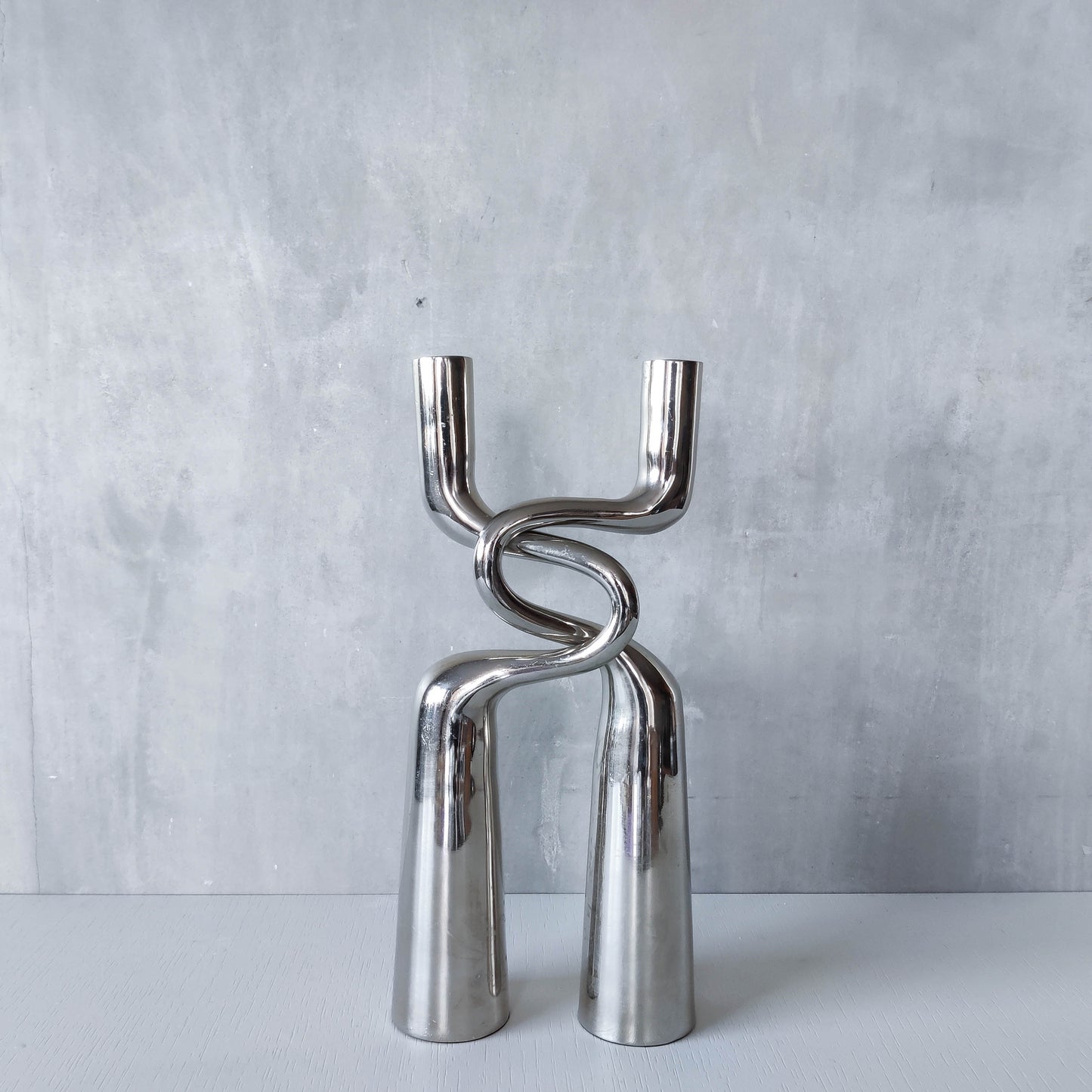 Pair of large curved chrome sculptural interlocking candle holders