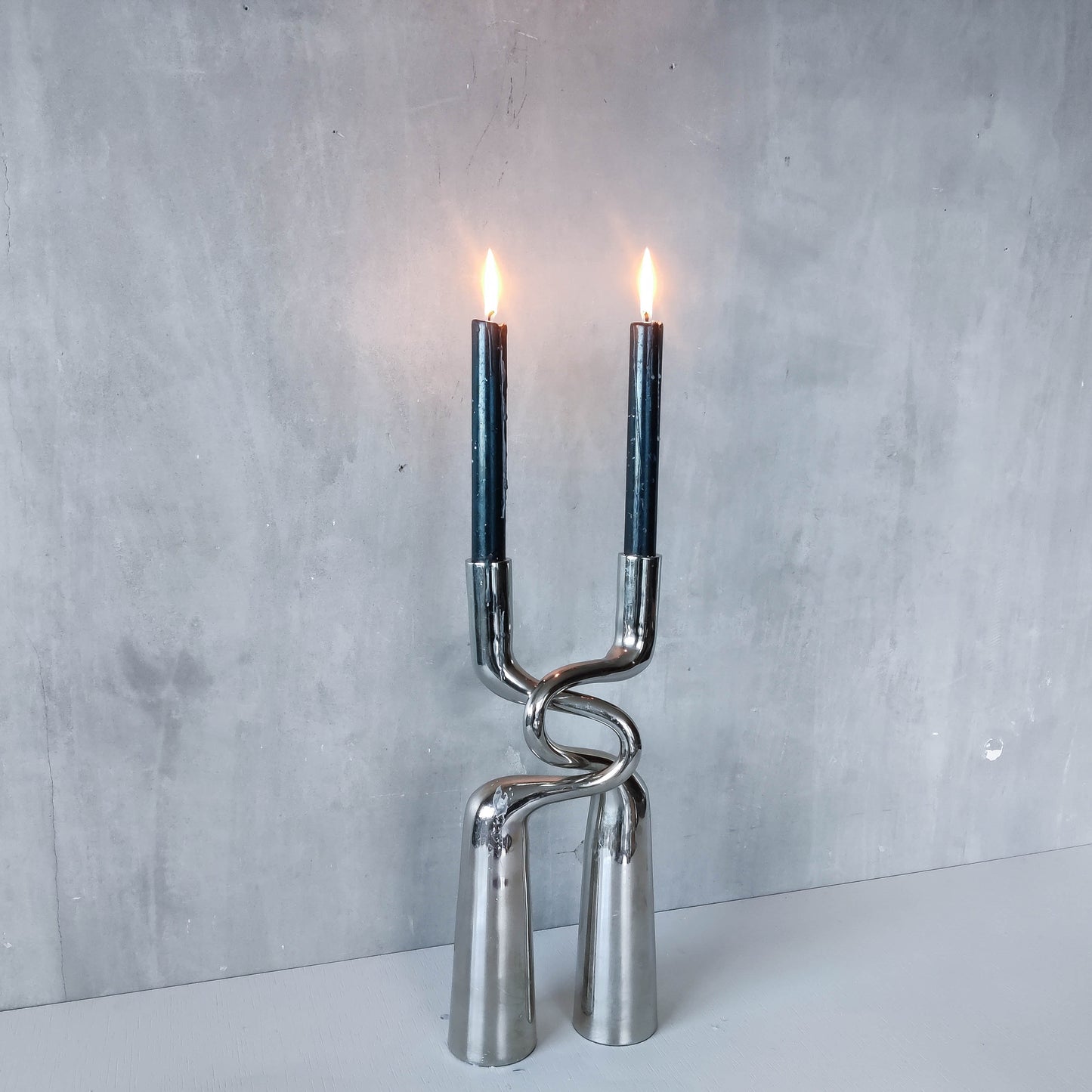 Pair of large curved chrome sculptural interlocking candle holders