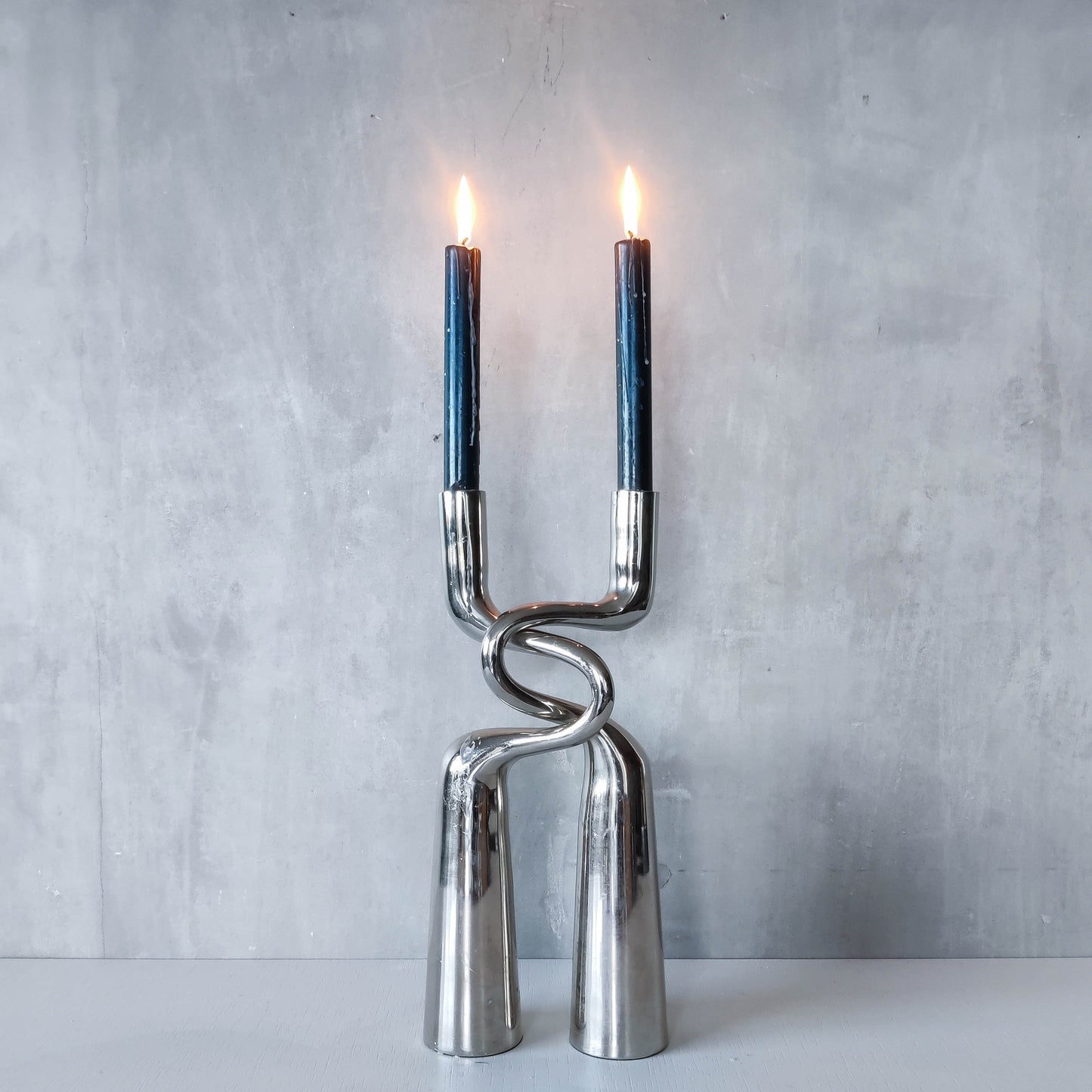 Pair of large curved chrome sculptural interlocking candle holders