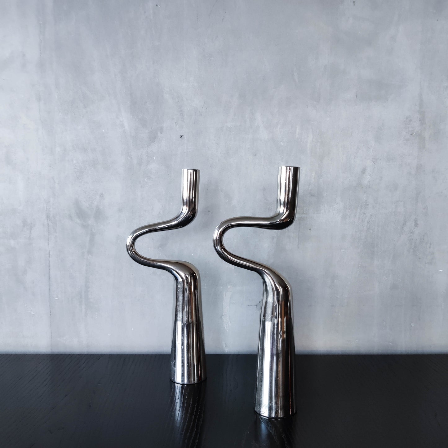Pair of large curved chrome sculptural interlocking candle holders