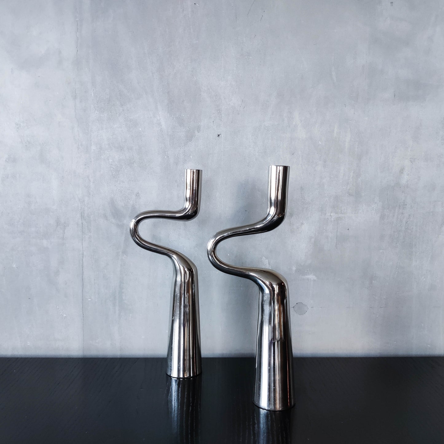 Pair of large curved chrome sculptural interlocking candle holders