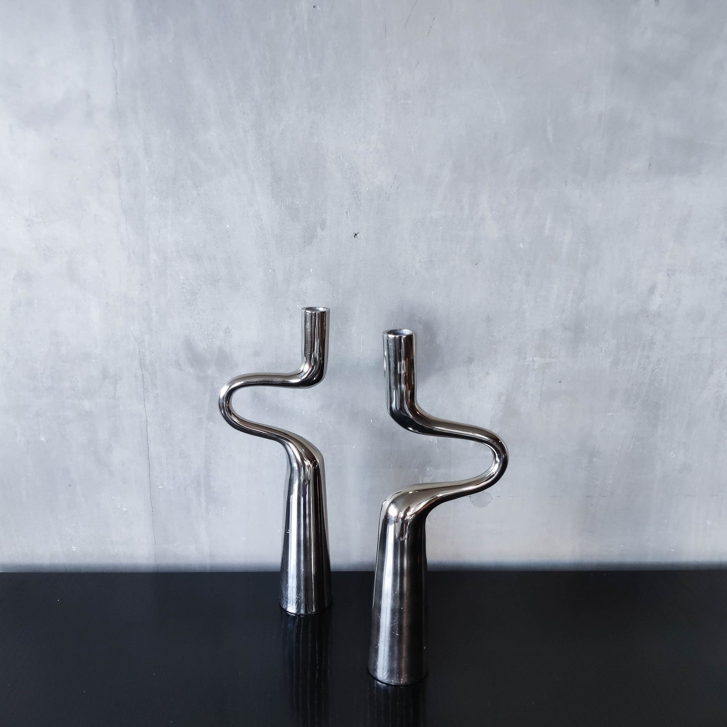 Pair of large curved chrome sculptural interlocking candle holders