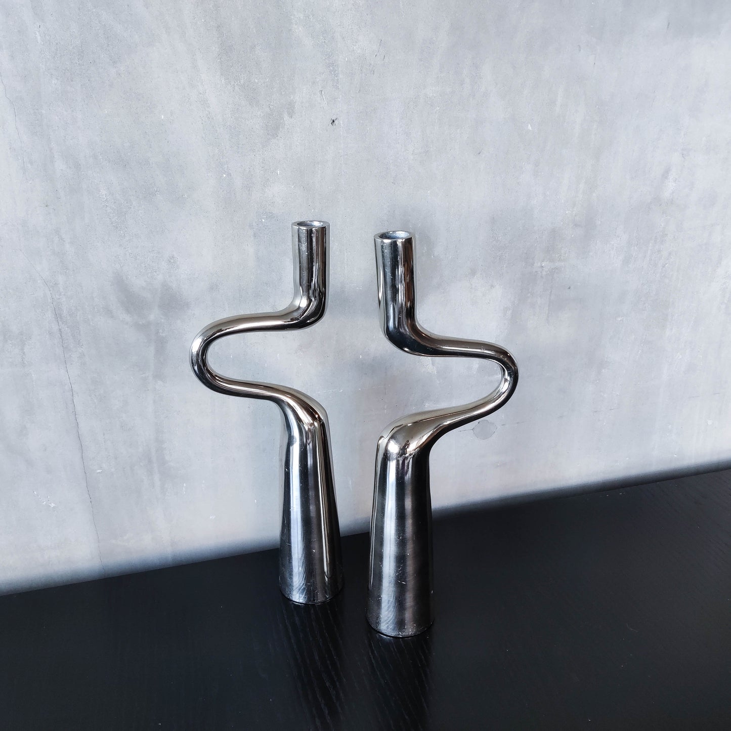 Pair of large curved chrome sculptural interlocking candle holders