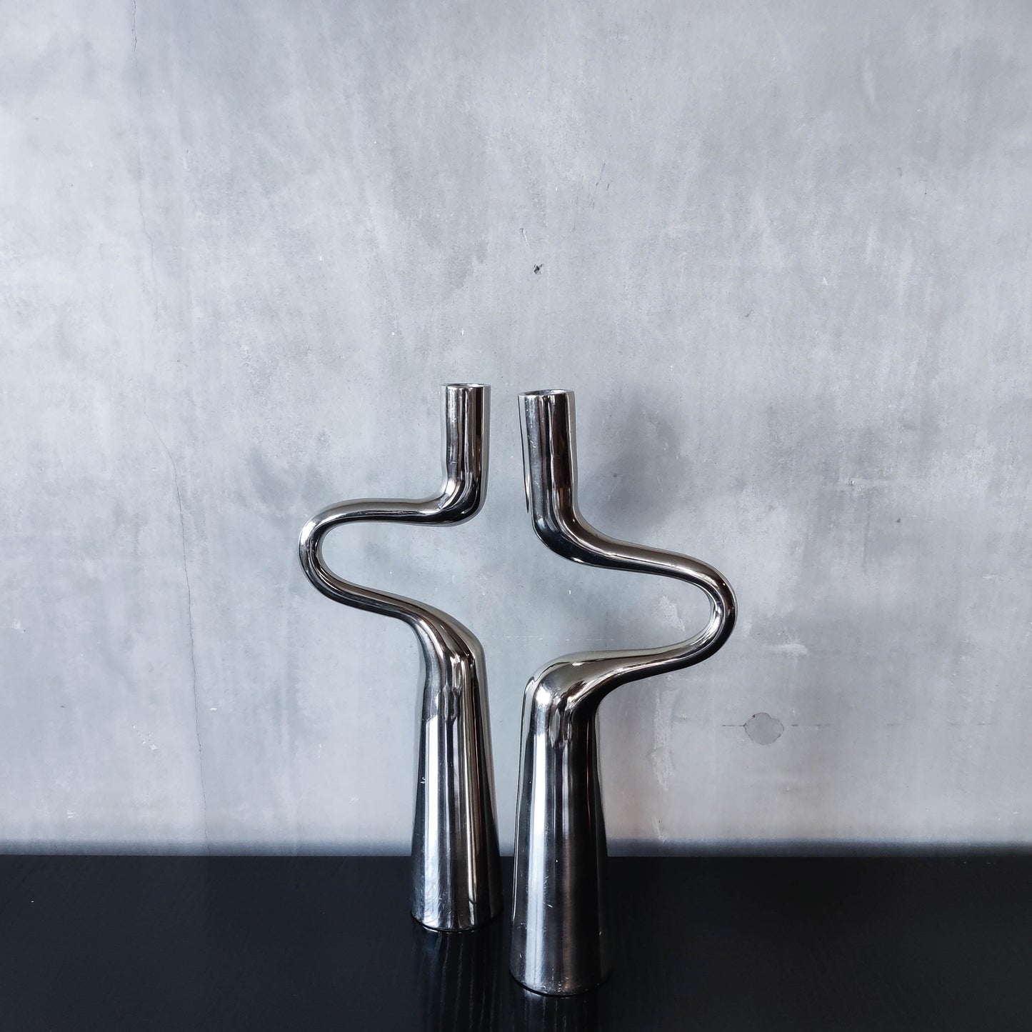 Pair of large curved chrome sculptural interlocking candle holders