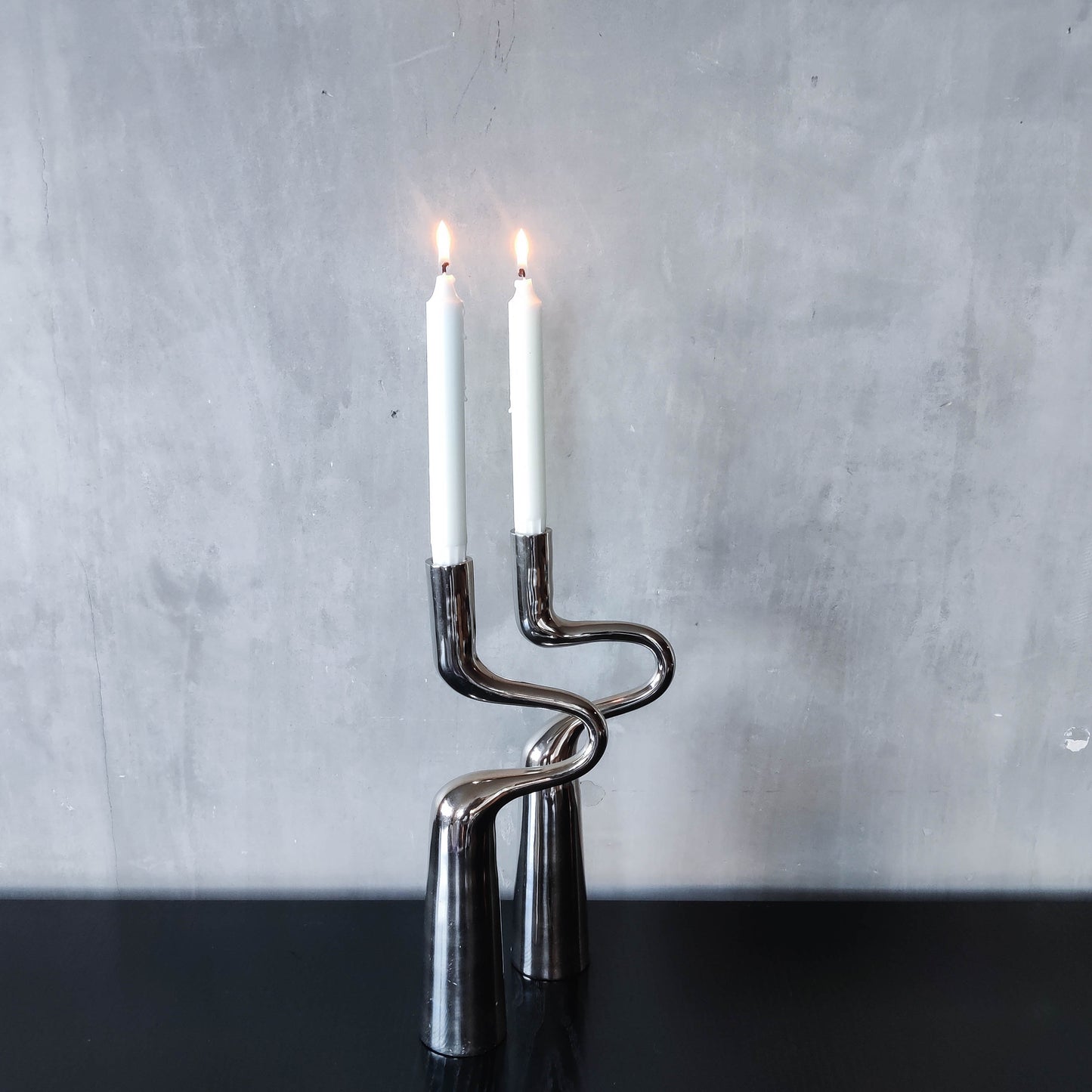 Pair of large curved chrome sculptural interlocking candle holders