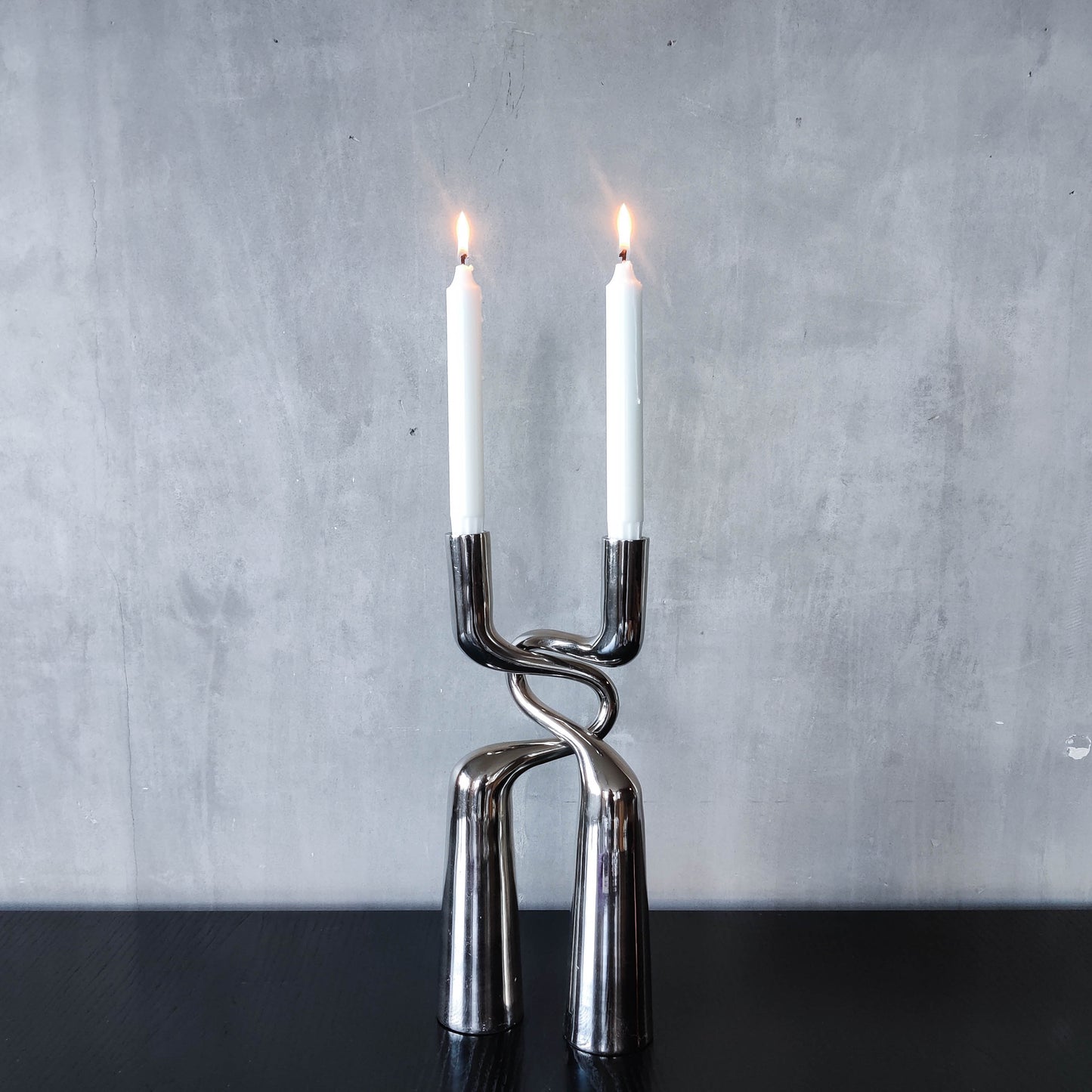 Pair of large curved chrome sculptural interlocking candle holders