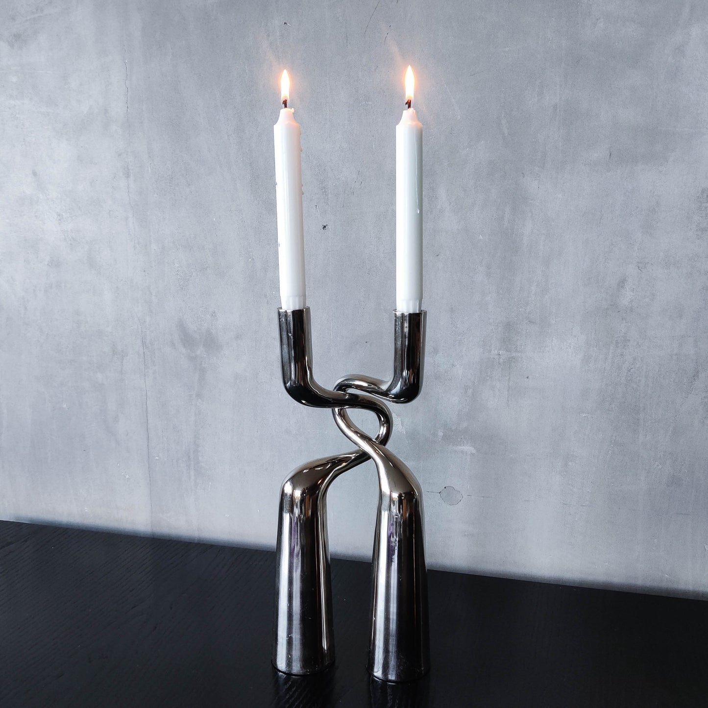 Pair of large curved chrome sculptural interlocking candle holders