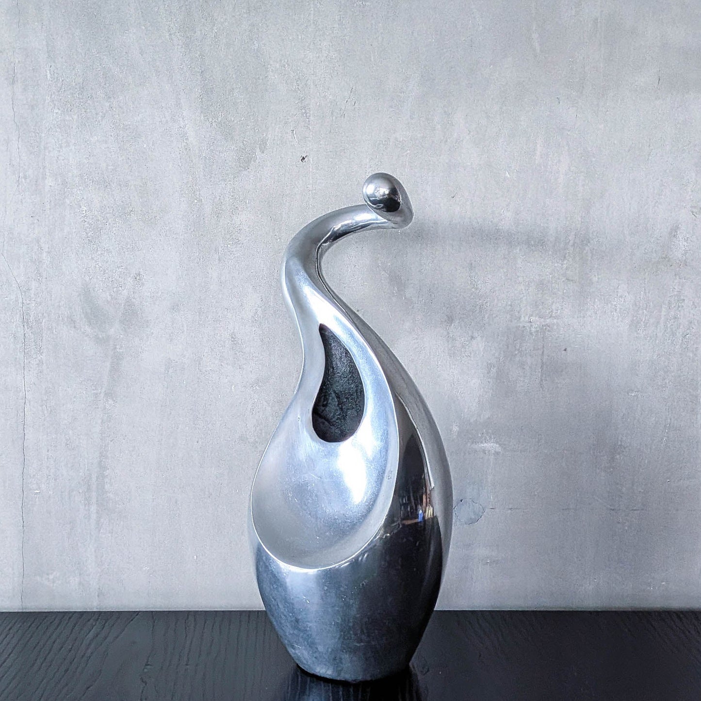 A vintage cast aluminium abstract surrealist twisted vase vessel