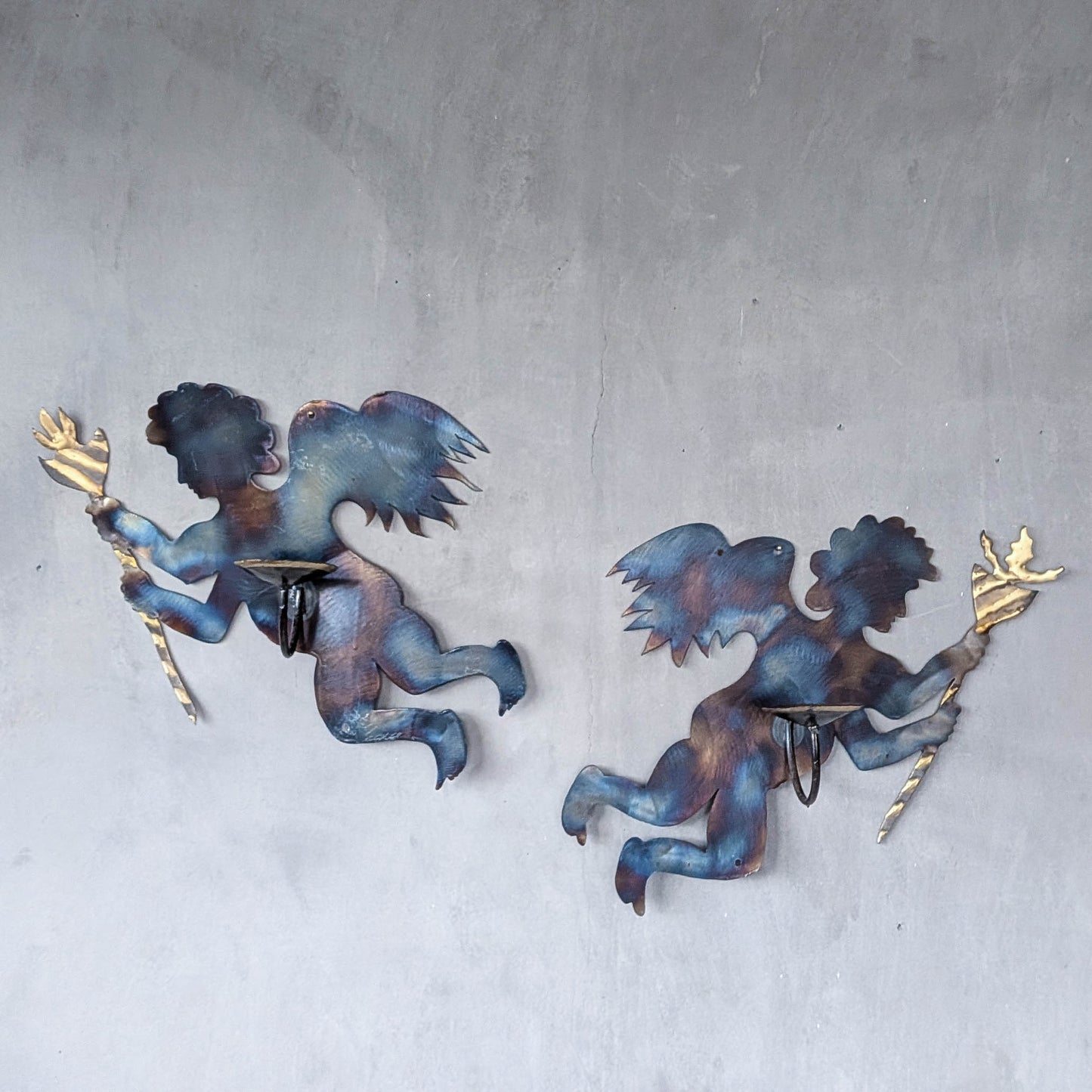 Pair of vintage metalwork torch cut steel cherub wall candle sconces