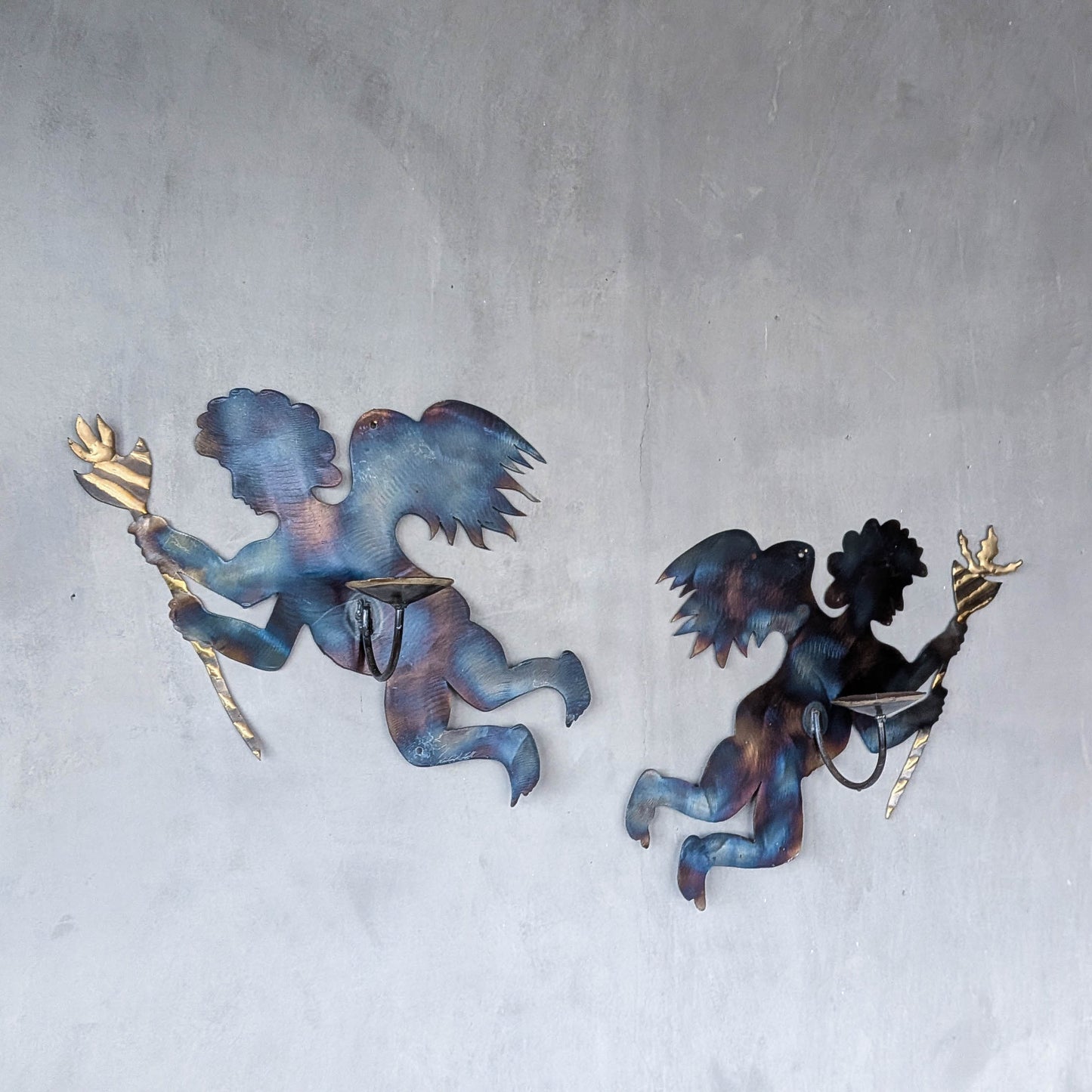 Pair of vintage metalwork torch cut steel cherub wall candle sconces