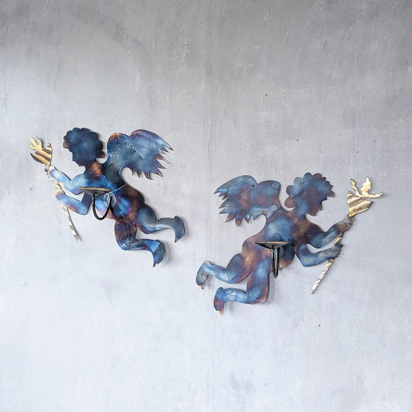 Pair of vintage metalwork torch cut steel cherub wall candle sconces
