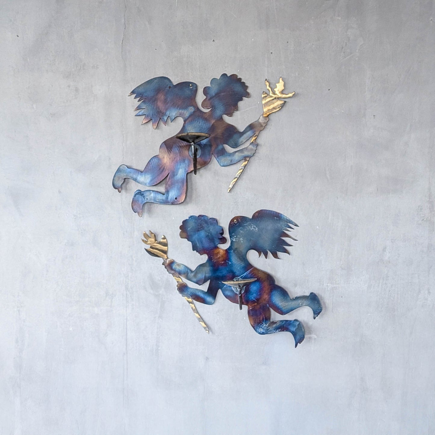 Pair of vintage metalwork torch cut steel cherub wall candle sconces