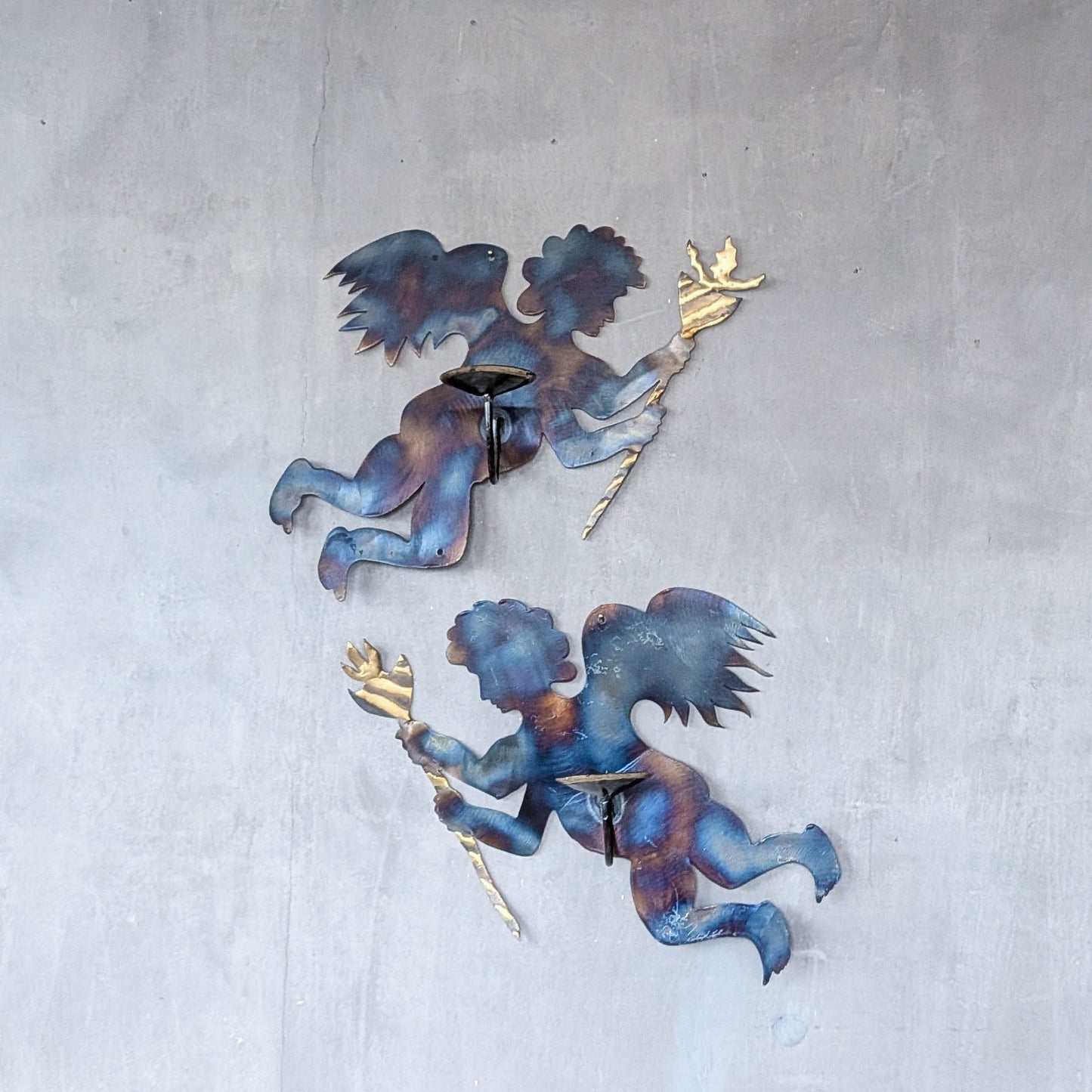 Pair of vintage metalwork torch cut steel cherub wall candle sconces
