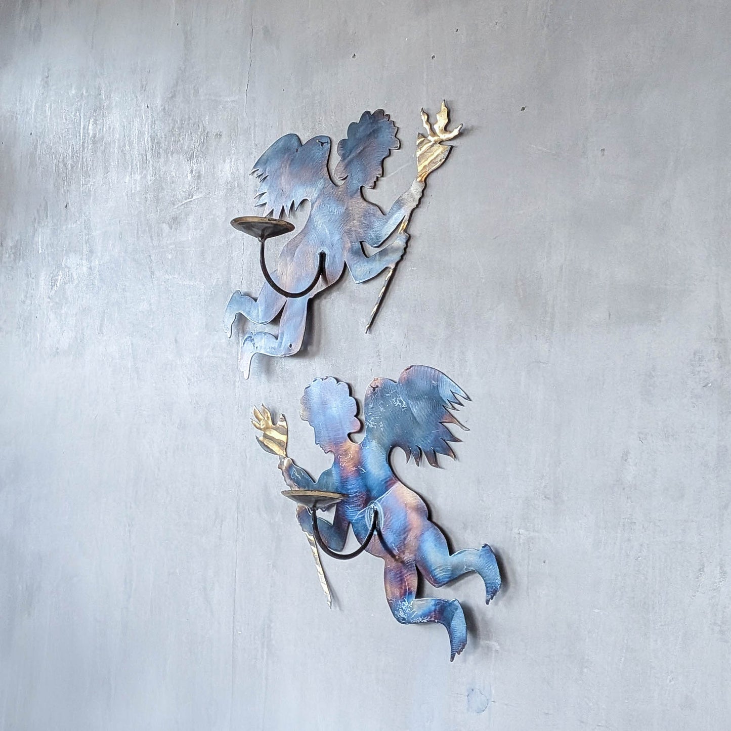 Pair of vintage metalwork torch cut steel cherub wall candle sconces