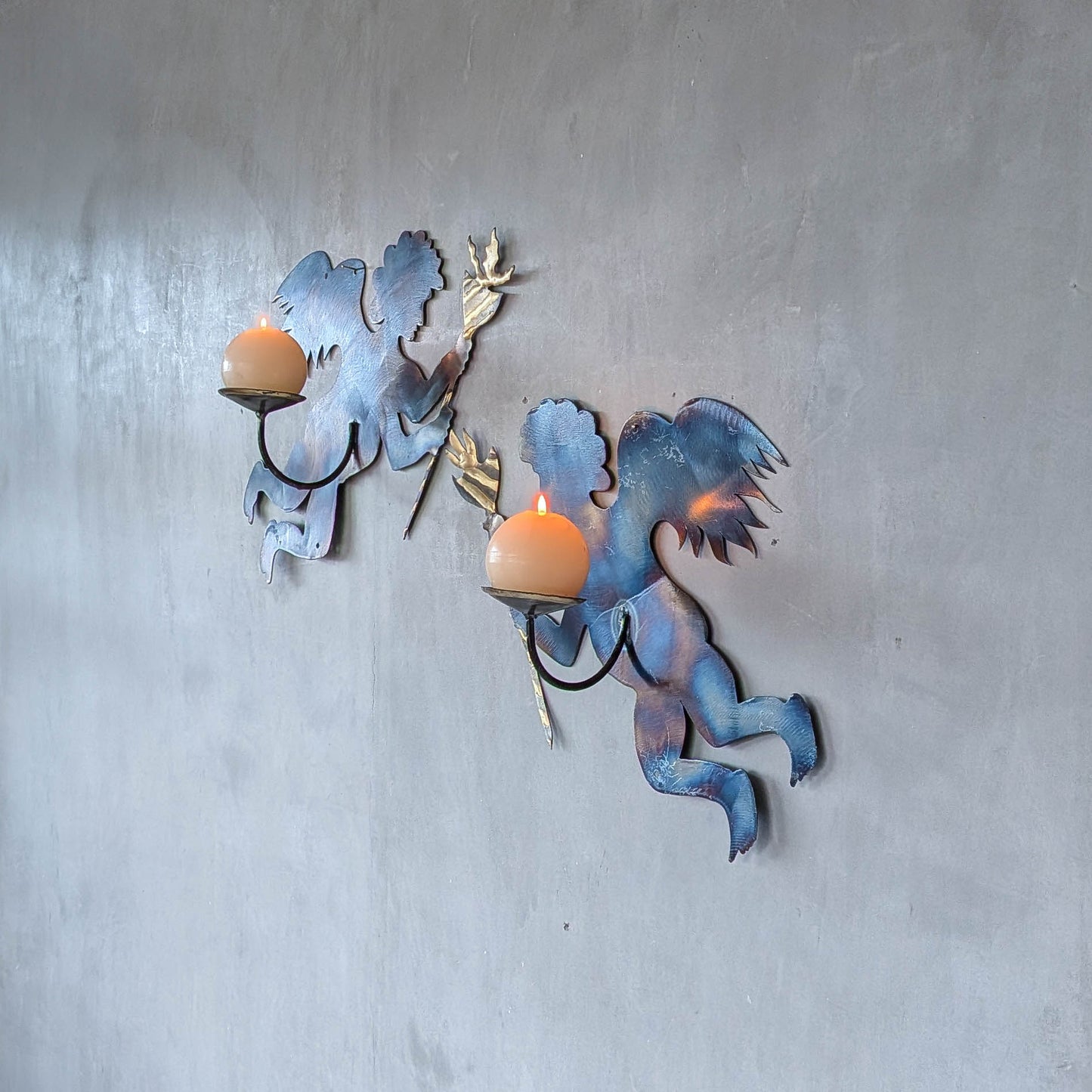 Pair of vintage metalwork torch cut steel cherub wall candle sconces