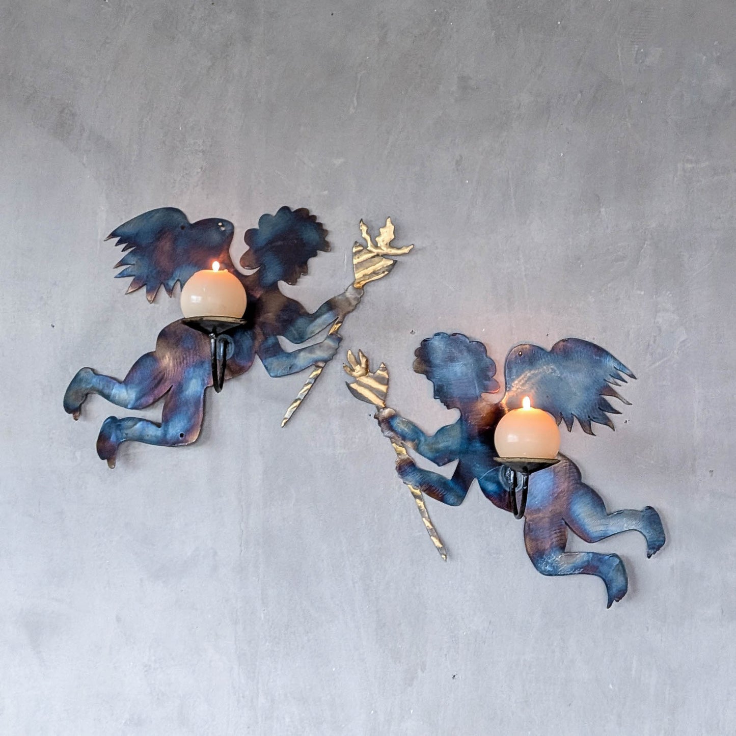 Pair of vintage metalwork torch cut steel cherub wall candle sconces