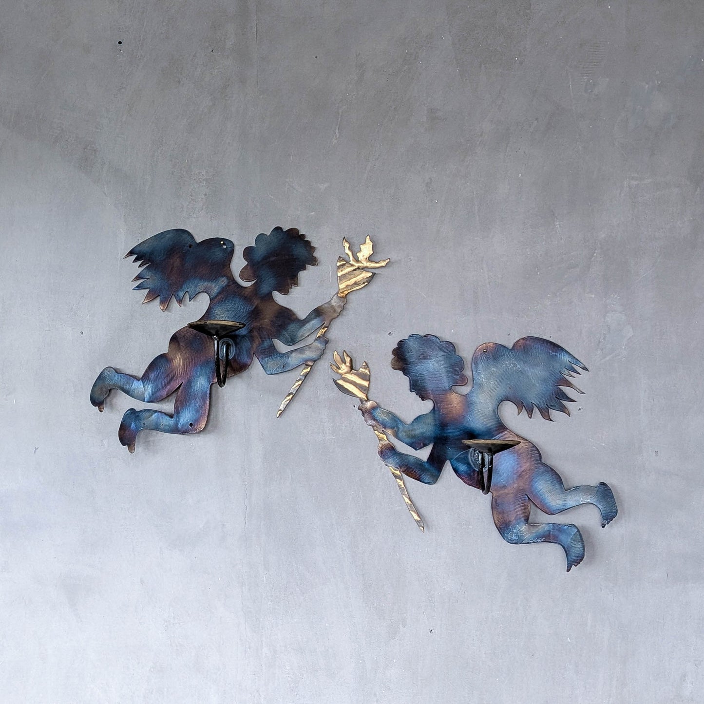 Pair of vintage metalwork torch cut steel cherub wall candle sconces