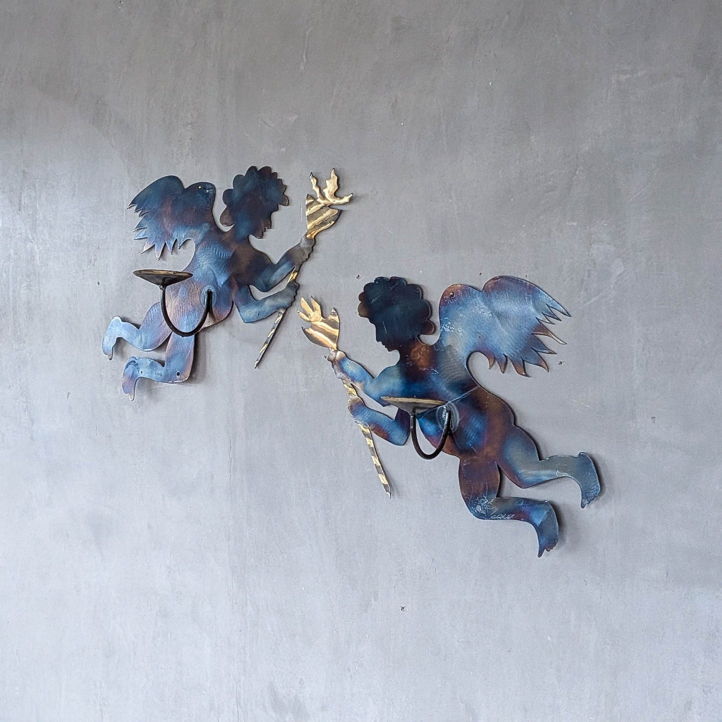Pair of vintage metalwork torch cut steel cherub wall candle sconces