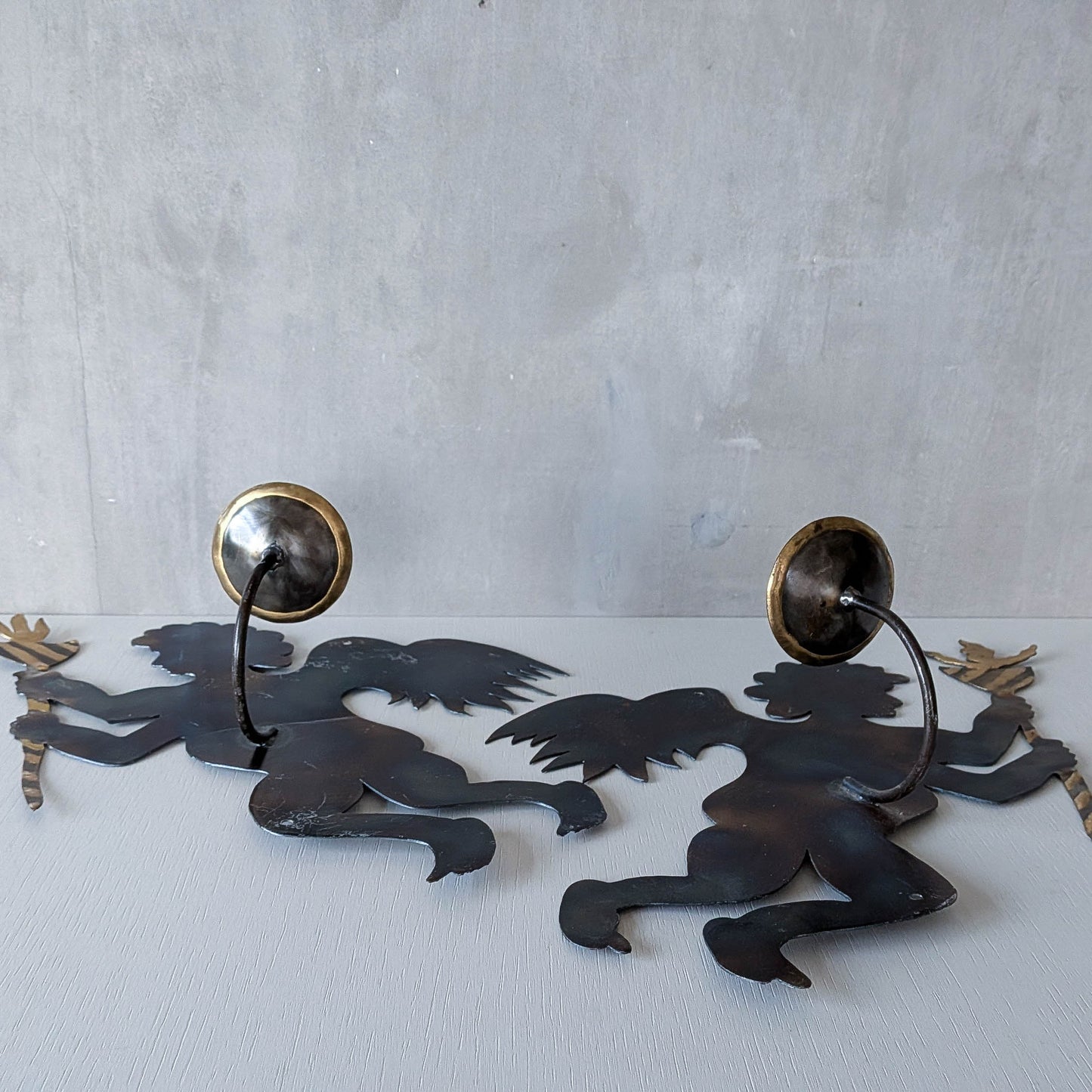 Pair of vintage metalwork torch cut steel cherub wall candle sconces