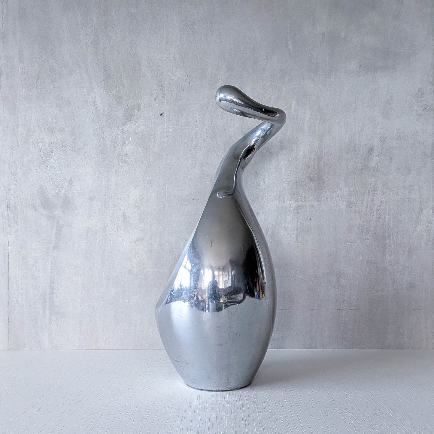 A vintage cast aluminium abstract surrealist twisted vase vessel