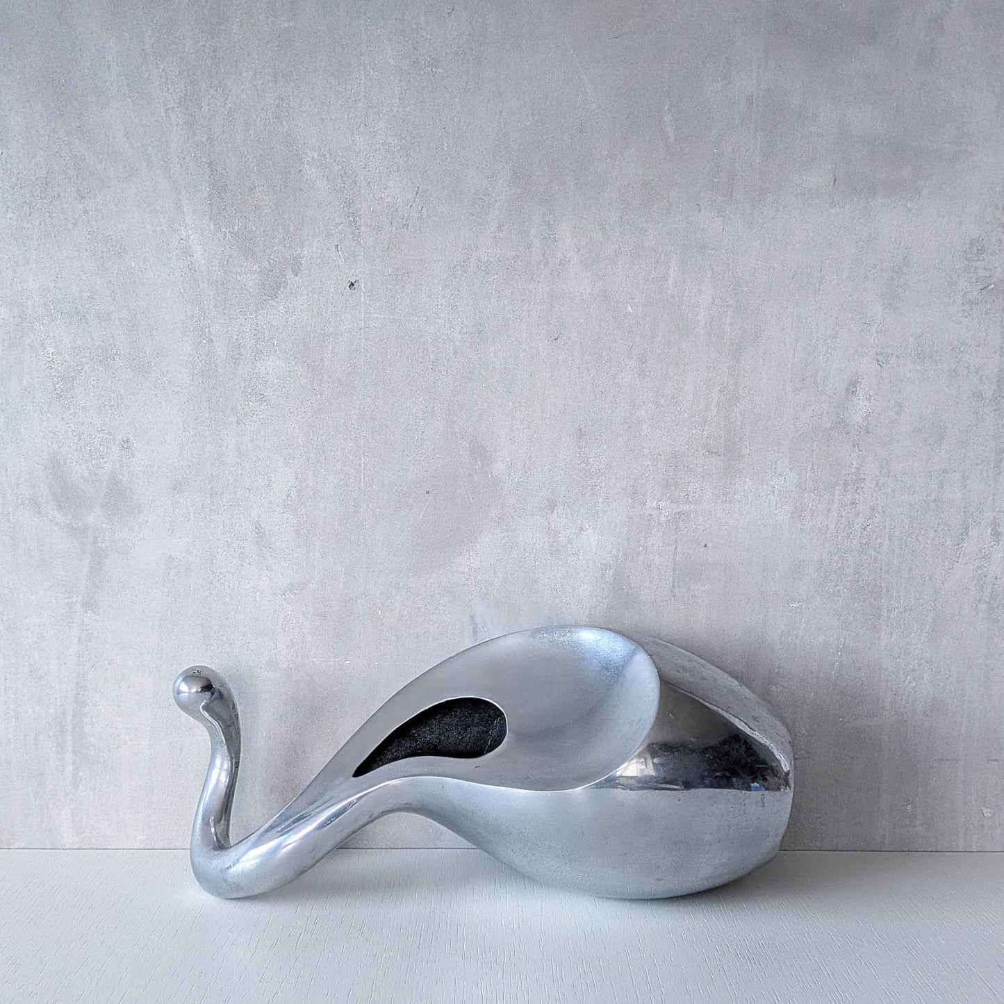 A vintage cast aluminium abstract surrealist twisted vase vessel