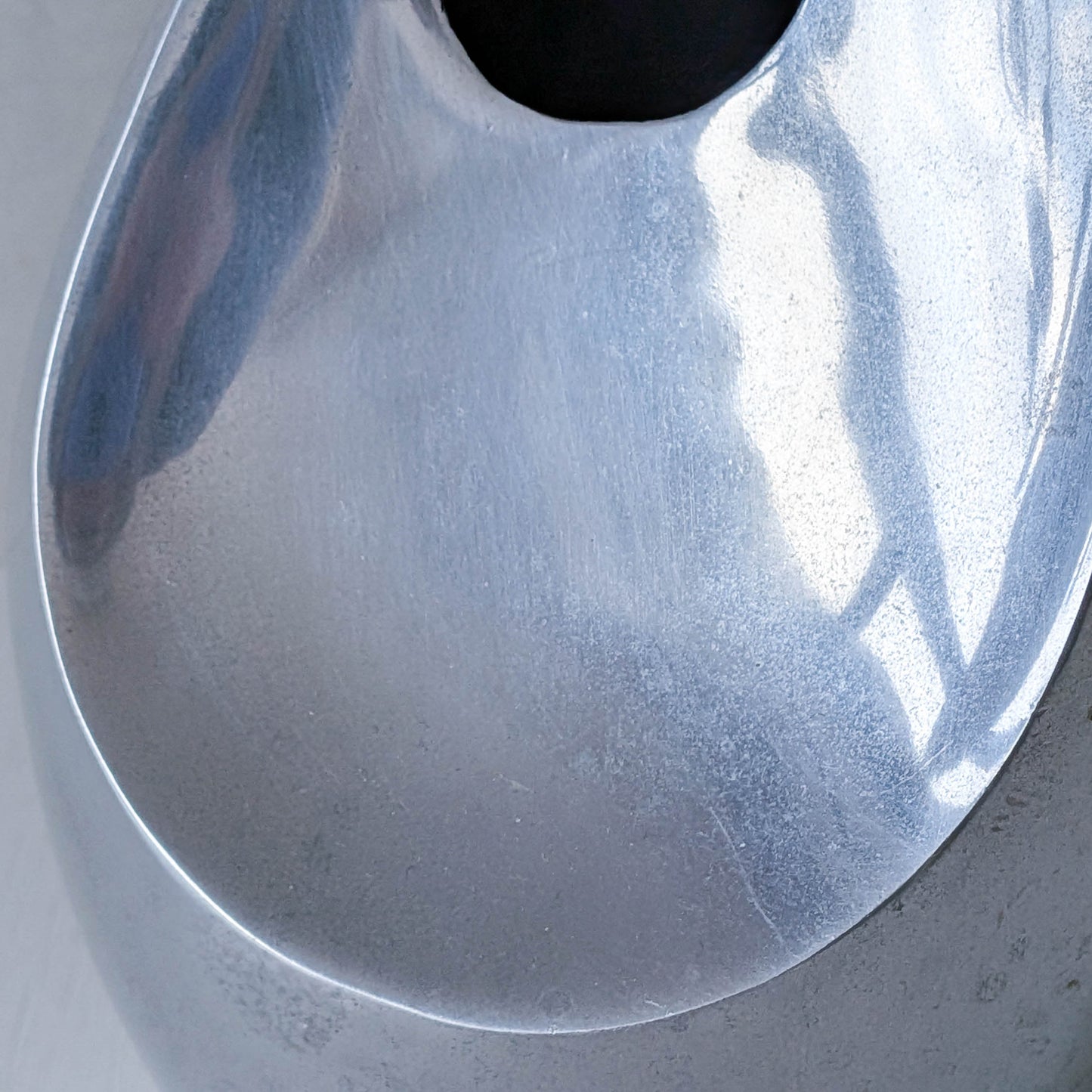 A vintage cast aluminium abstract surrealist twisted vase vessel