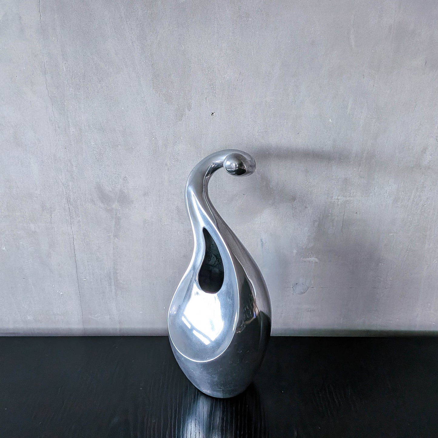 A vintage cast aluminium abstract surrealist twisted vase vessel