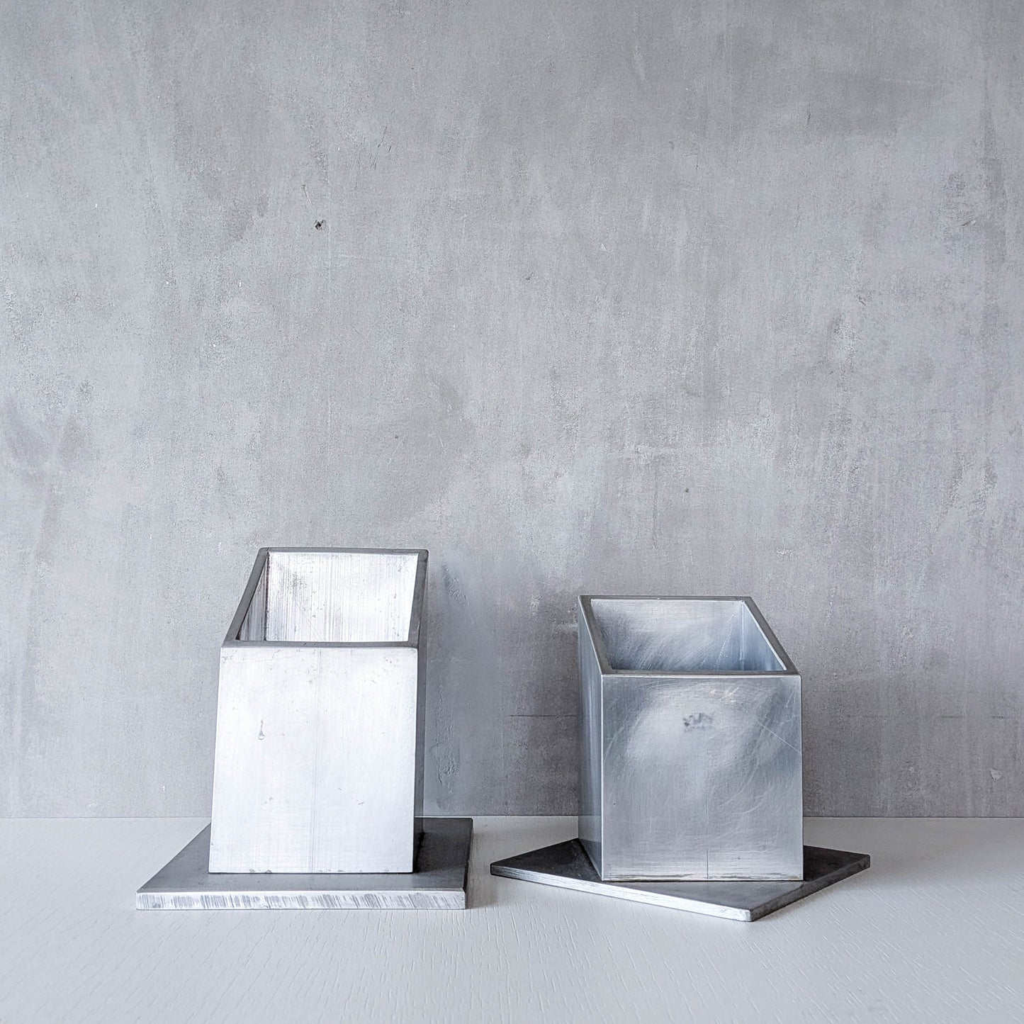 Pair of vintage scratch built sculptural aluminium desk tidy pen holders