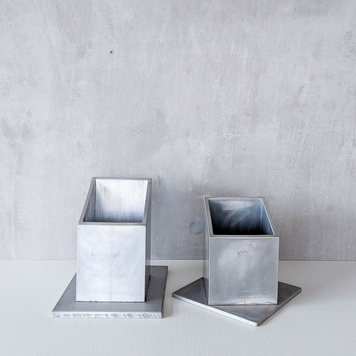 Pair of vintage scratch built sculptural aluminium desk tidy pen holders